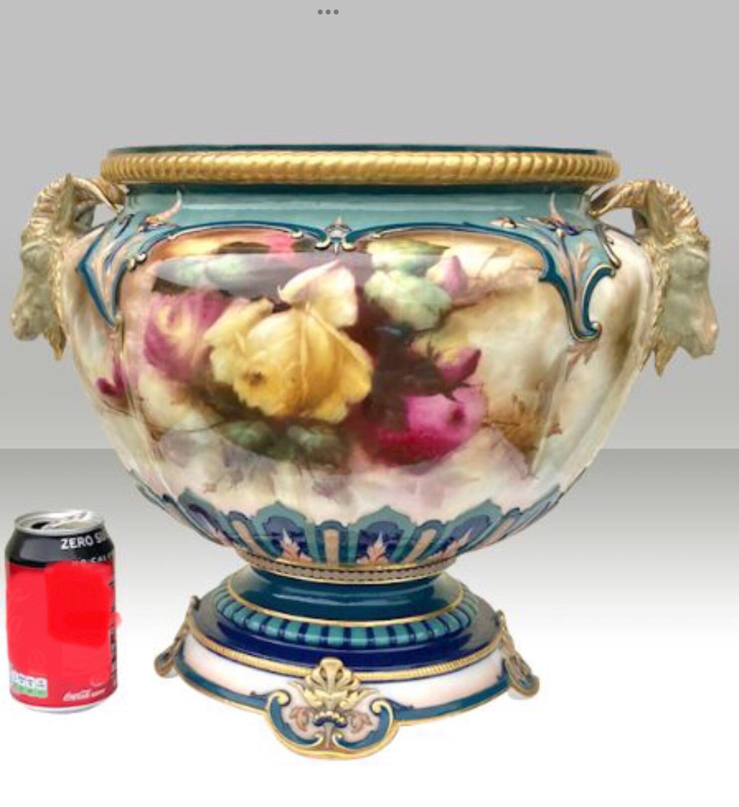 Magnificent Large Antique Royal Worcester Footed Jardiniere,Bowl,Vase,Beautifully Hand Painted Front and Rear With Red,Yellow Roses and Foliage.Surmounted Each Side With Horned Rams Heads.
Stunning Condition,Modelled by Hadley,Painted And Signed By