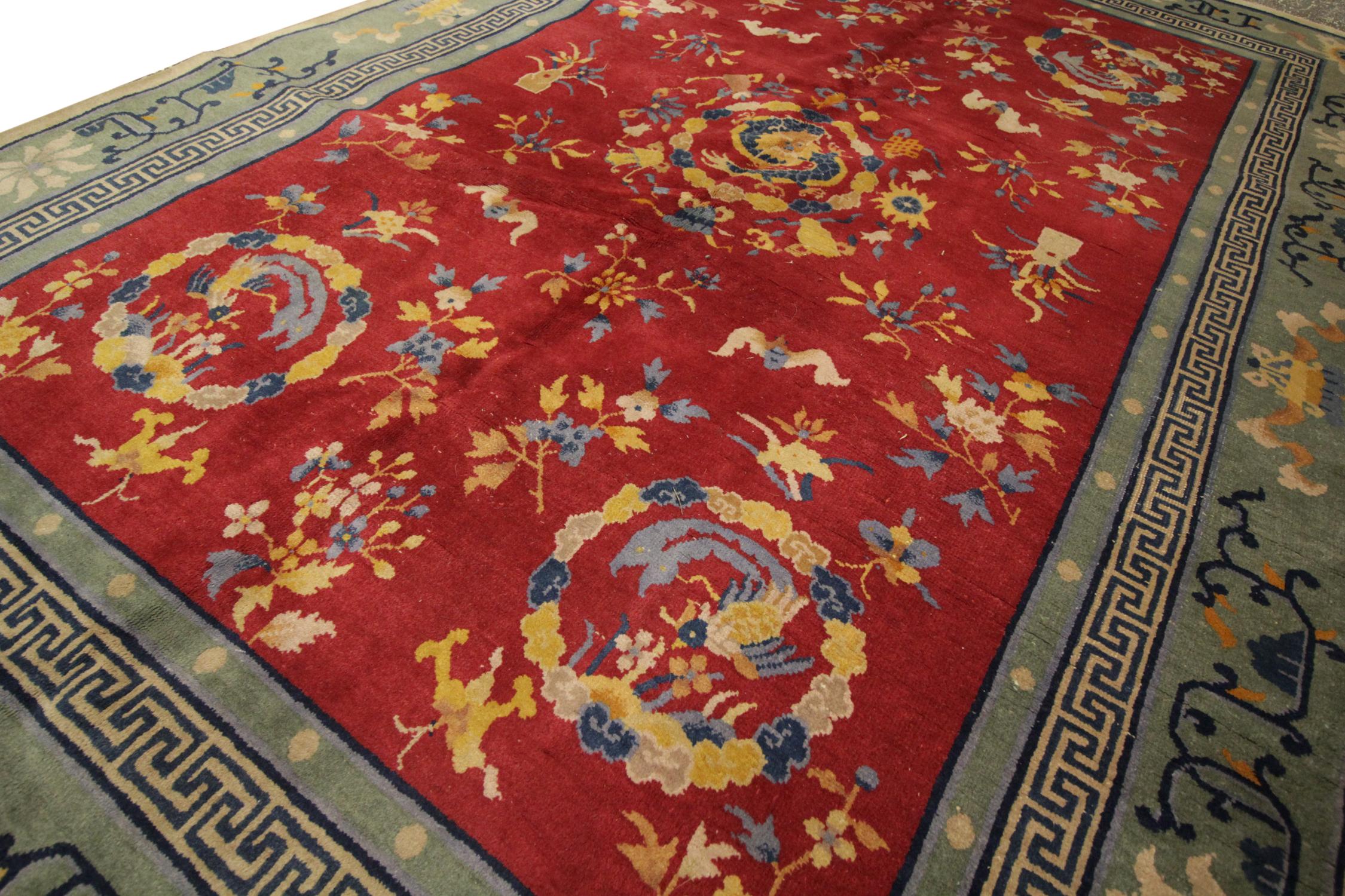 Ce magnifique tapis Art déco ancien tissé à la main a été fabriqué dans les années 1890 en Chine avec de la laine fine filée à la main. Le motif est symétrique et présente des médaillons et des motifs uniques sur un champ rouge riche au centre, qui