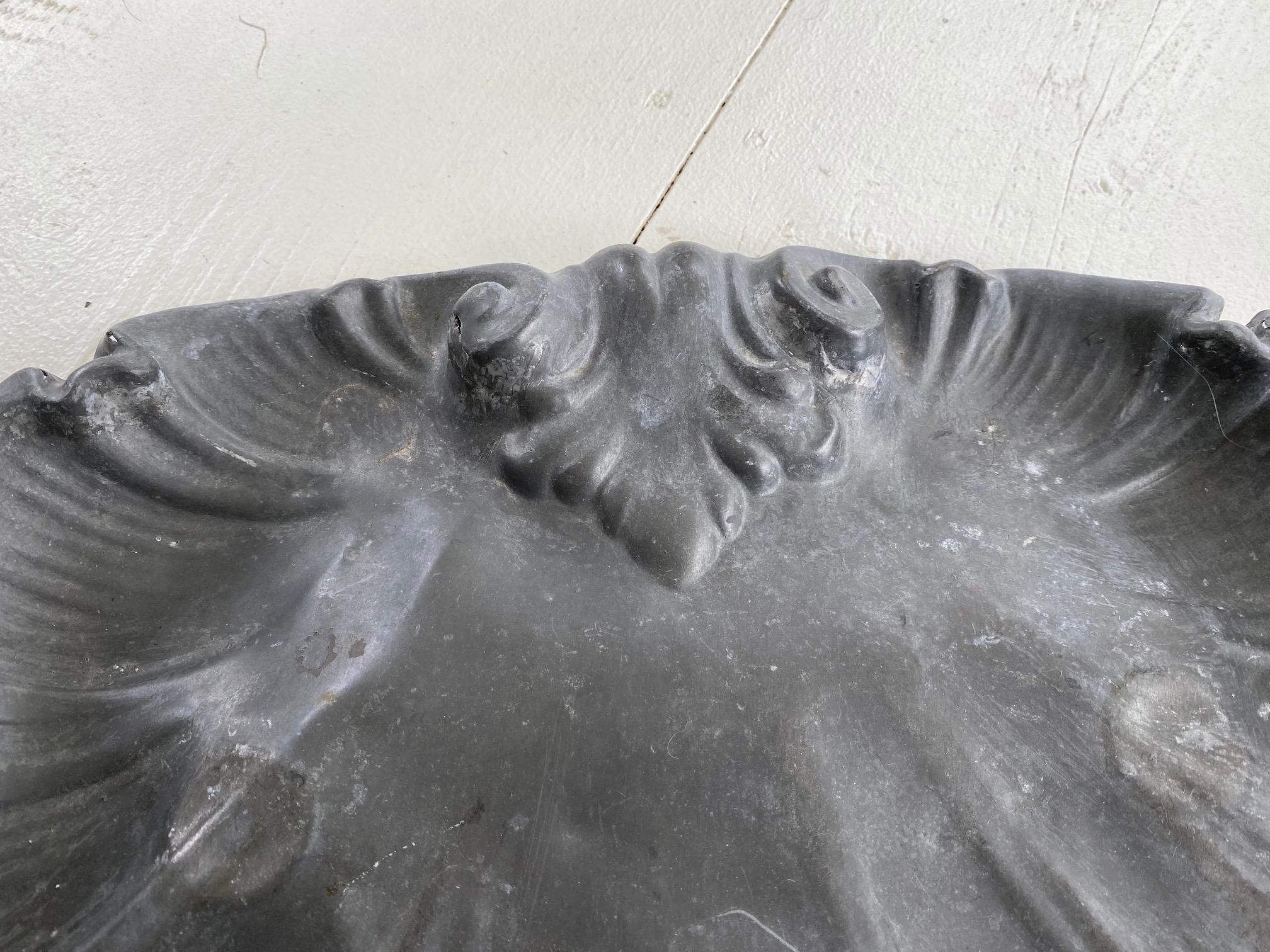 Unusual rustic French antique metal shell plate is made of metal with leaded color coating, a wonderful aged patina. The piece was possibly used in a commercial setting at a coach stop or a roadside inn but can now be used as centerpiece, decorative