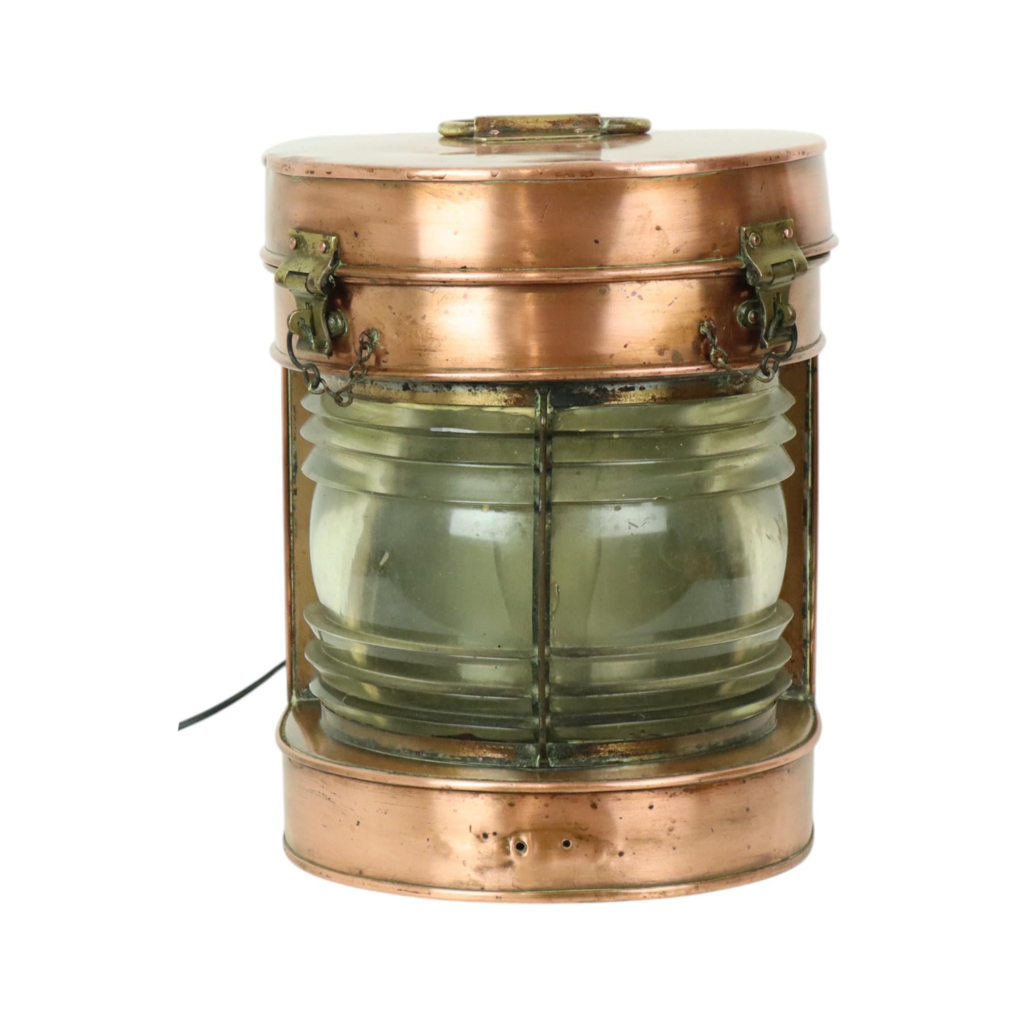 Large antique ship lamp, ship lantern, made of red copper, yellow copper, and a glass Fresnel lens, converted to electricity, early 20th century.

Beautiful and characterful object, not a replica but a lamp that has really been at sea, an authentic