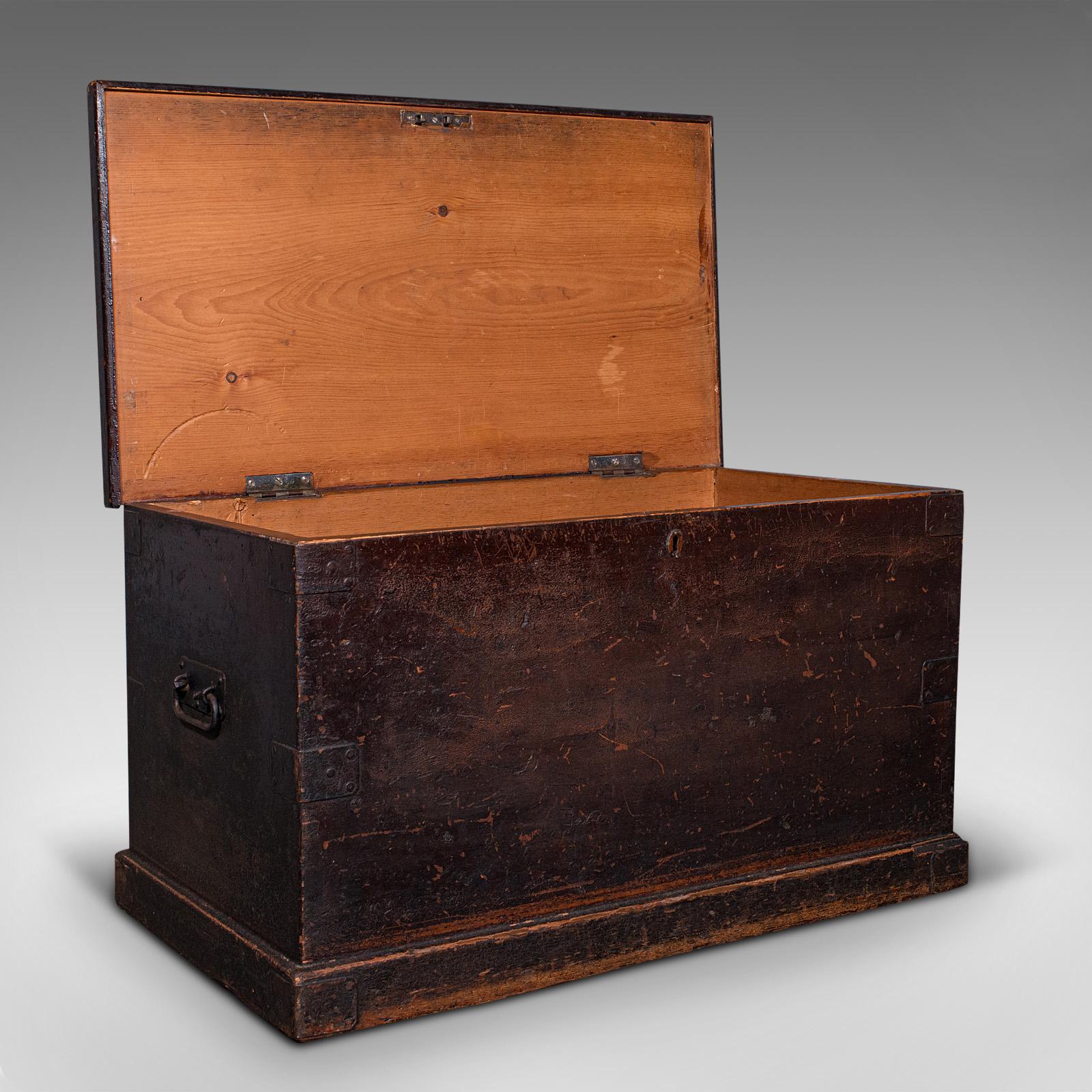 This is a large antique shipping trunk. An English, stained pine travel or tool chest, dating to the Victorian period, circa 1880.

Of generous size for voyages beyond the sea or near to home
Displays a desirable aged patina with weathered