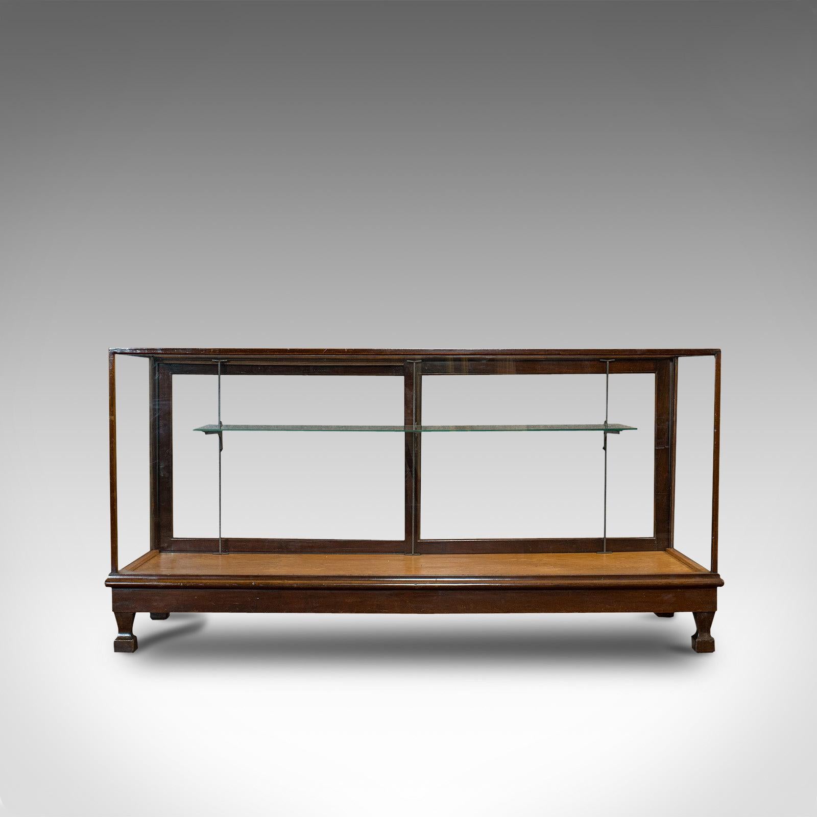This is a large antique shop display cabinet. An English, oak and glass showcase, dating to the Edwardian period, circa 1910.

Grand display case makes for superb viewing
Displays a desirable aged patina
Select oak offers fine grain