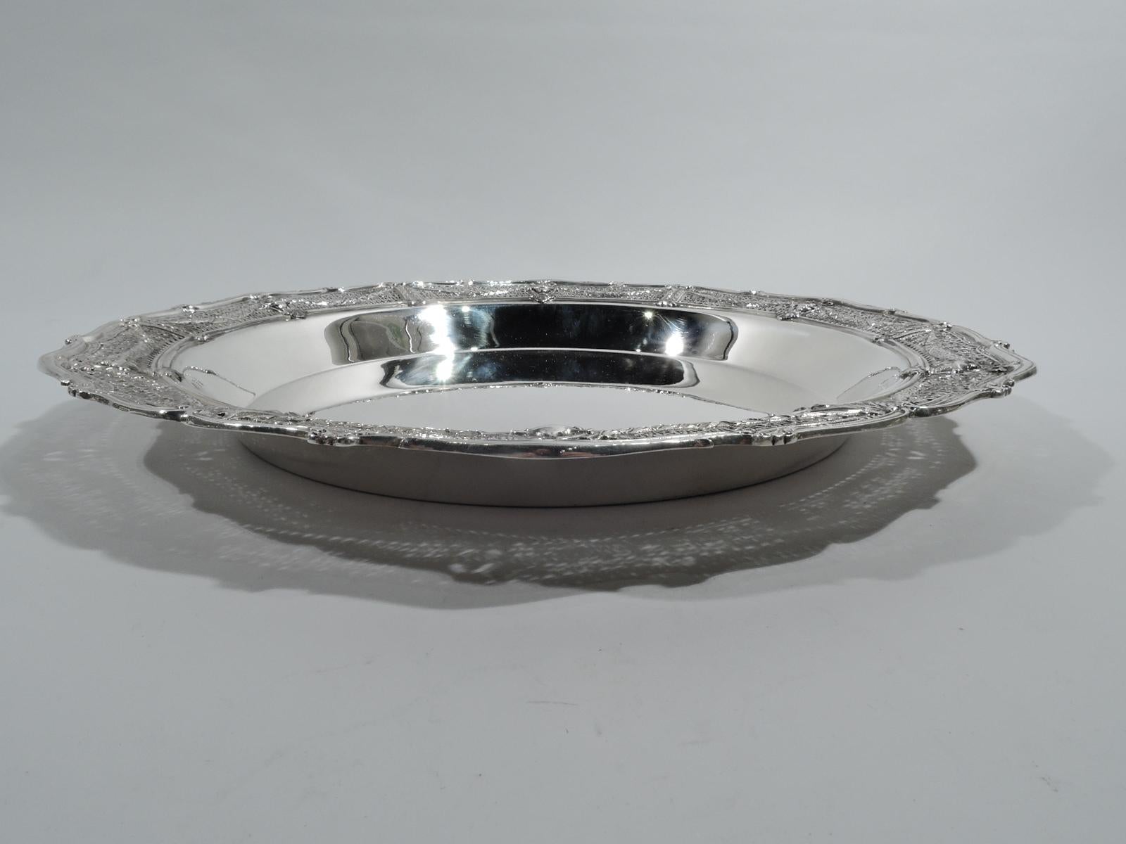 Edwardian Regency sterling silver centerpiece bowl in Adam pattern. Made by Shreve & Co. in San Francisco, ca 1915. Plain and solid well with tapering sides. Wide shoulder with Classical vases on open rondels joined by leaf swags on pierced fern