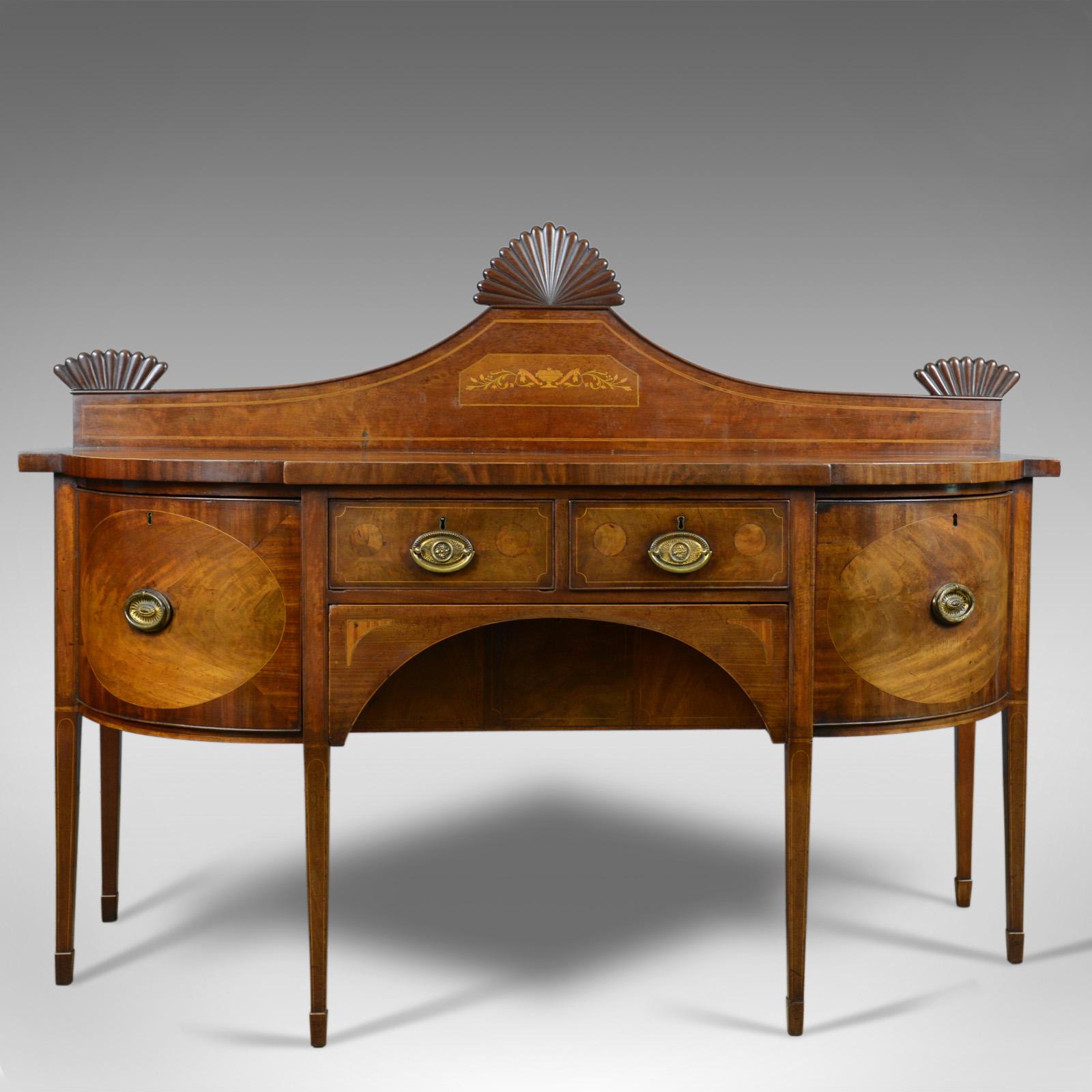 This is a large antique sideboard, an English, late Georgian server in mahogany dating to circa 1800.

Select mahogany with grain interest throughout
Desirable aged patina in the lustrous, wax polished finish
Displaying Sheraton influence and