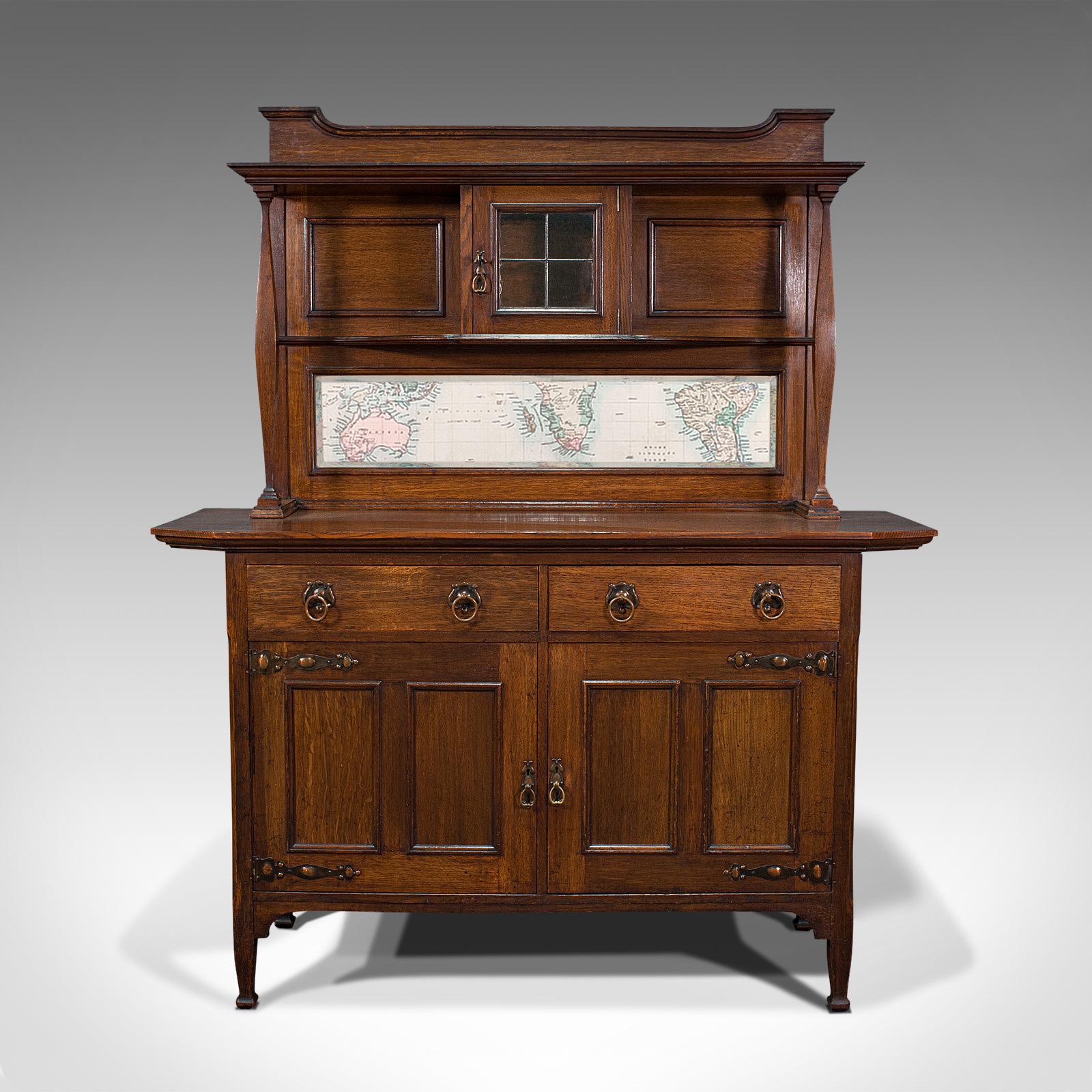 This is a large antique sideboard. An English, oak dresser cabinet by Liberty and Co in the Arts & Crafts taste, dating to the late Victorian period, circa 1900.

Captivating sideboard of superb quality and form
A classic Liberty & Co, London