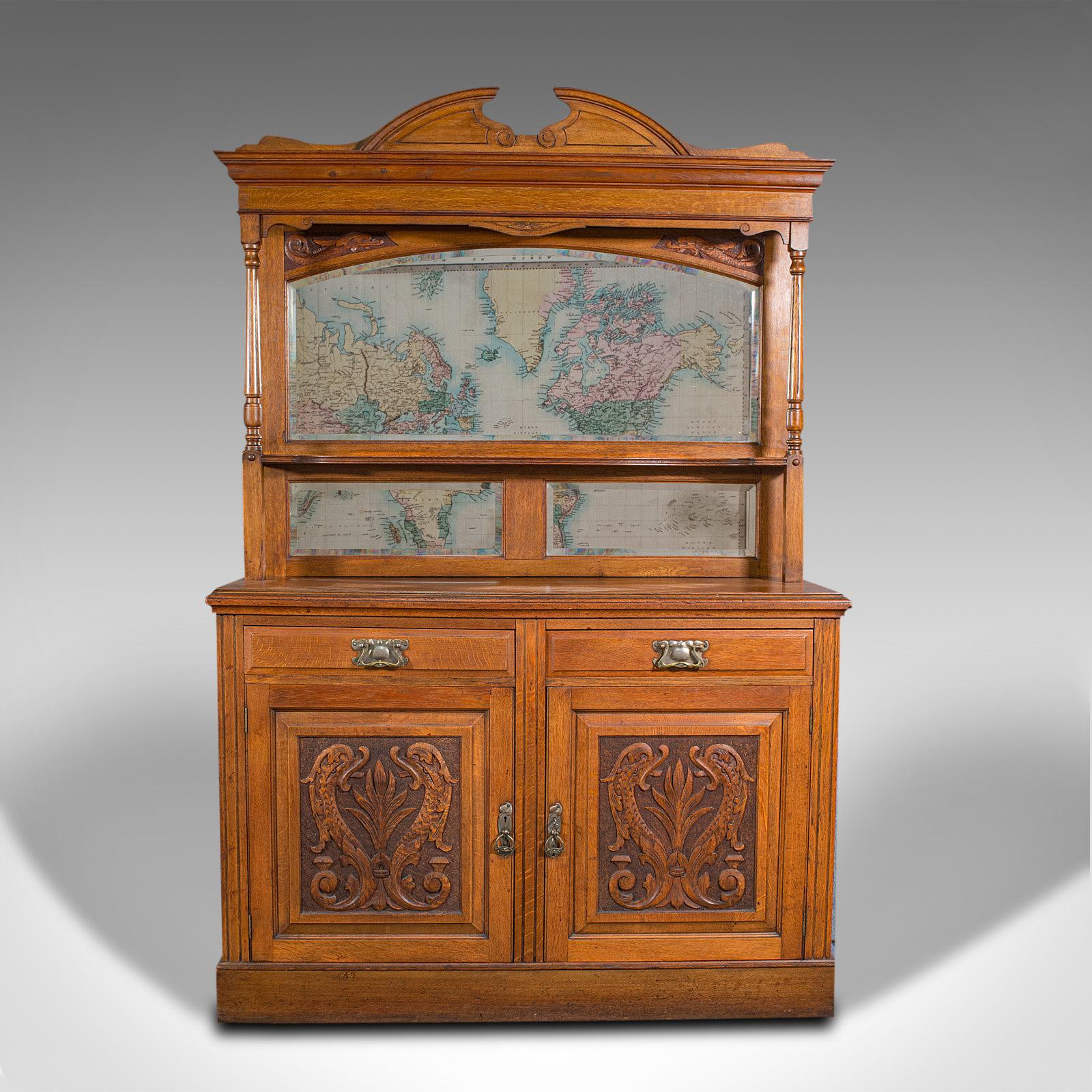 This is a large antique sideboard. An English, oak mirror back cabinet, dating to the Arts & Crafts movement during the late Victorian period, circa 1900.

Imperious proportion with elegant craftsmanship
Displays a desirable aged patina and