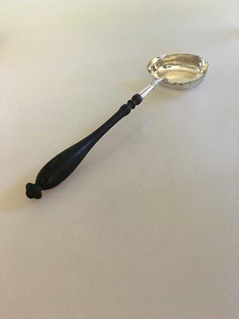 Large antique silver punch spoon with wooden shaft.

Measures: 38 cm L (14 61/64
