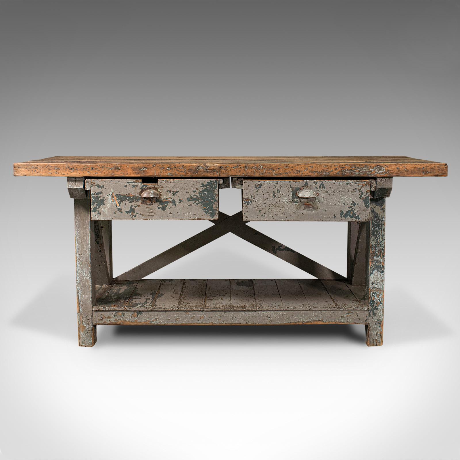 This is a large antique silversmith's bench. An English, pine industrial craftsman's table, dating to the Victorian period, circa 1900.

Wonderfully stout and strong antique artisan's table
Displays a desirable aged patina throughout
Thick