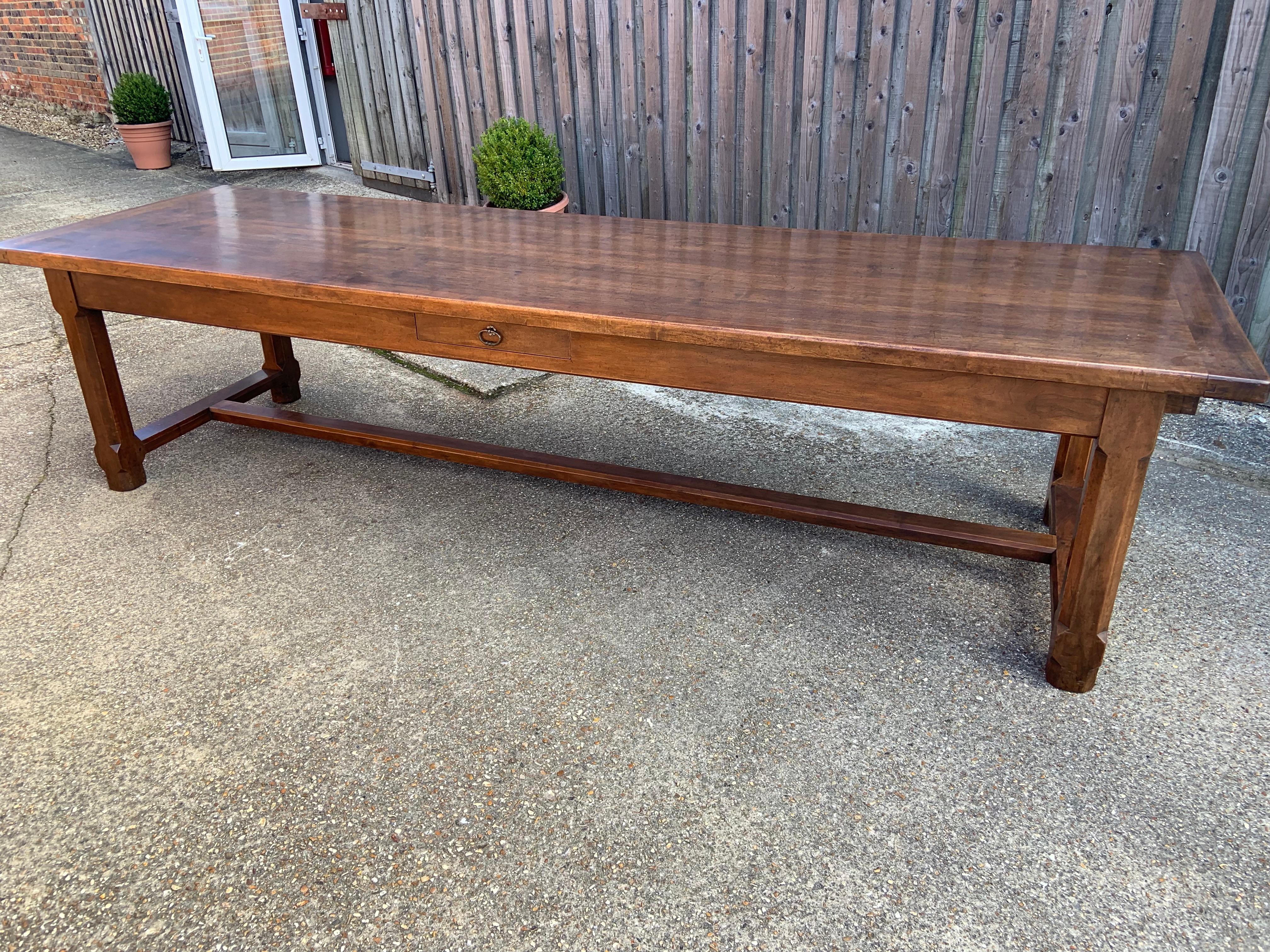 Large Antique solid walnut farmhouse table with gorgeous colour and patination. The top has cleated ends and stands on a solid Walnut base with square chamfered legs united by a centre stretcher. The legs are very thick and sturdy again making this