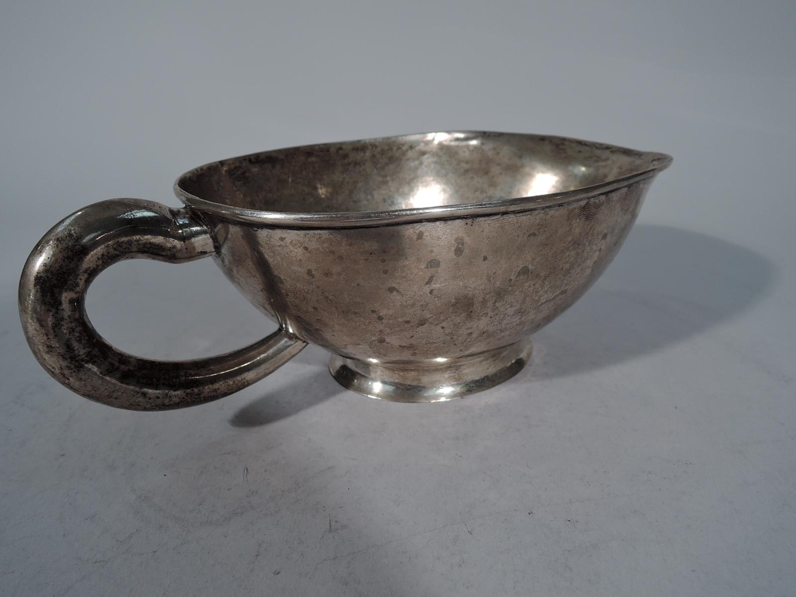 Large South American silver gravy boat, early 20th century. Ovoid with curved sides and wide lip spout. Elongated C-scroll handle and spread and raised oval foot. Visible handwork. Weight: 8 troy ounces.