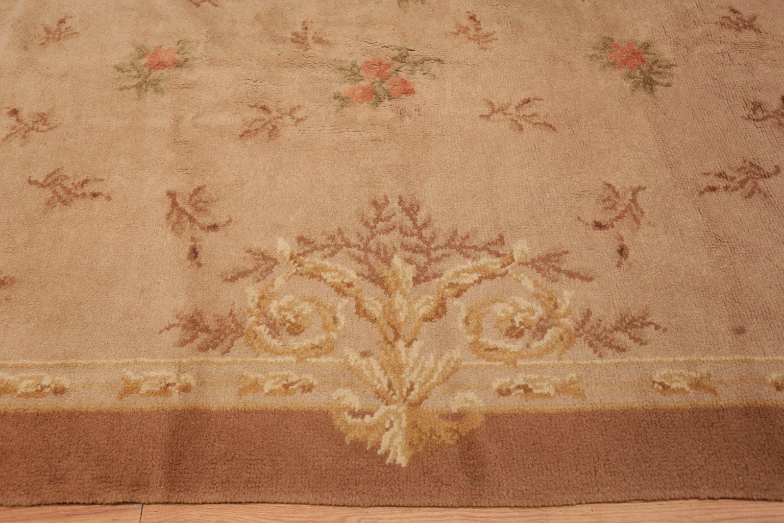 Antique large size Spanish carpet, country of origin: Spain, date: circa 1920. Size: 10 ft 7 in x 18 ft (3.23 m x 5.49 m).

A soft, tan frame surrounds the center of this antique carpet, creating a beautiful degree of grounding that allows the rest