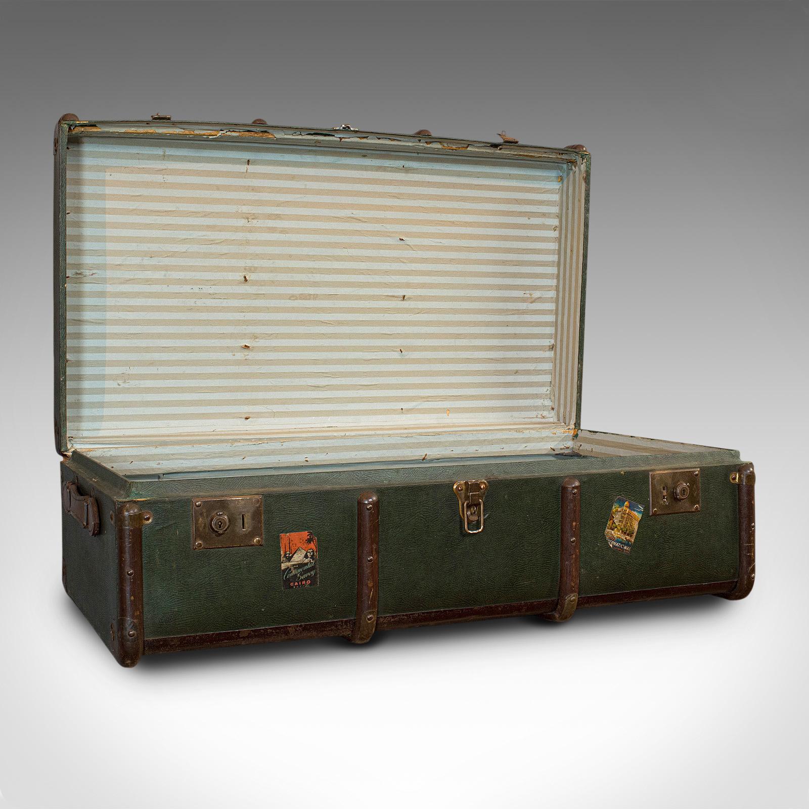 This is a large antique steamer chest. An English, canvas bound travel trunk with Drawco patent steel, dating to the Edwardian period, circa 1910.

Generously sized trunk from the golden age of voyages
Displays a desirable aged patina
Wooden