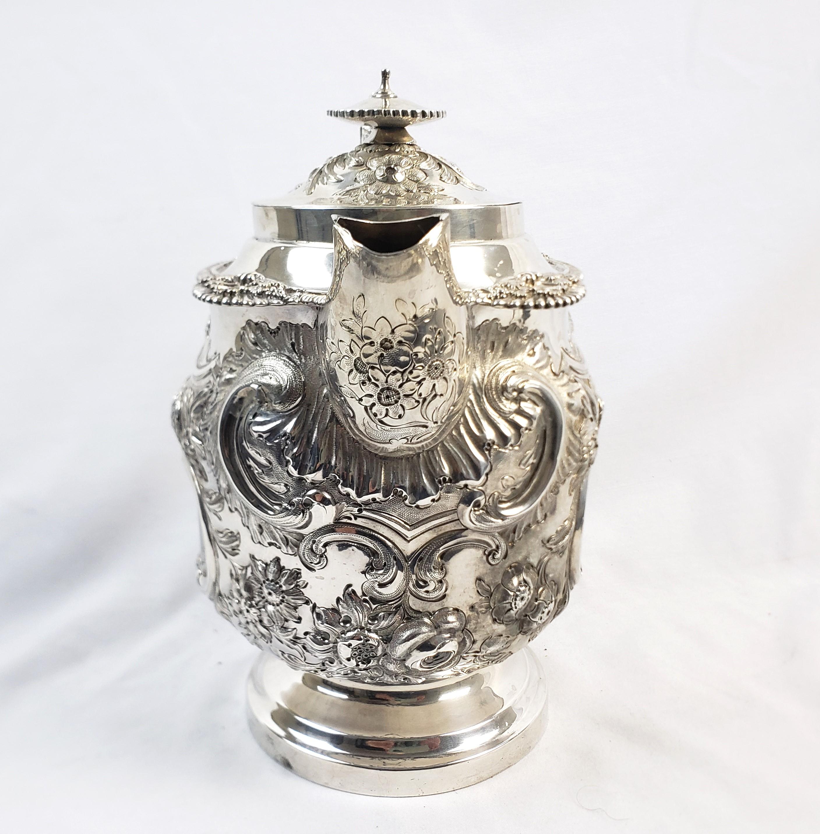 English Large Antique Sterling Silver Georgian Teapot with Ornate Repousse Decoration For Sale
