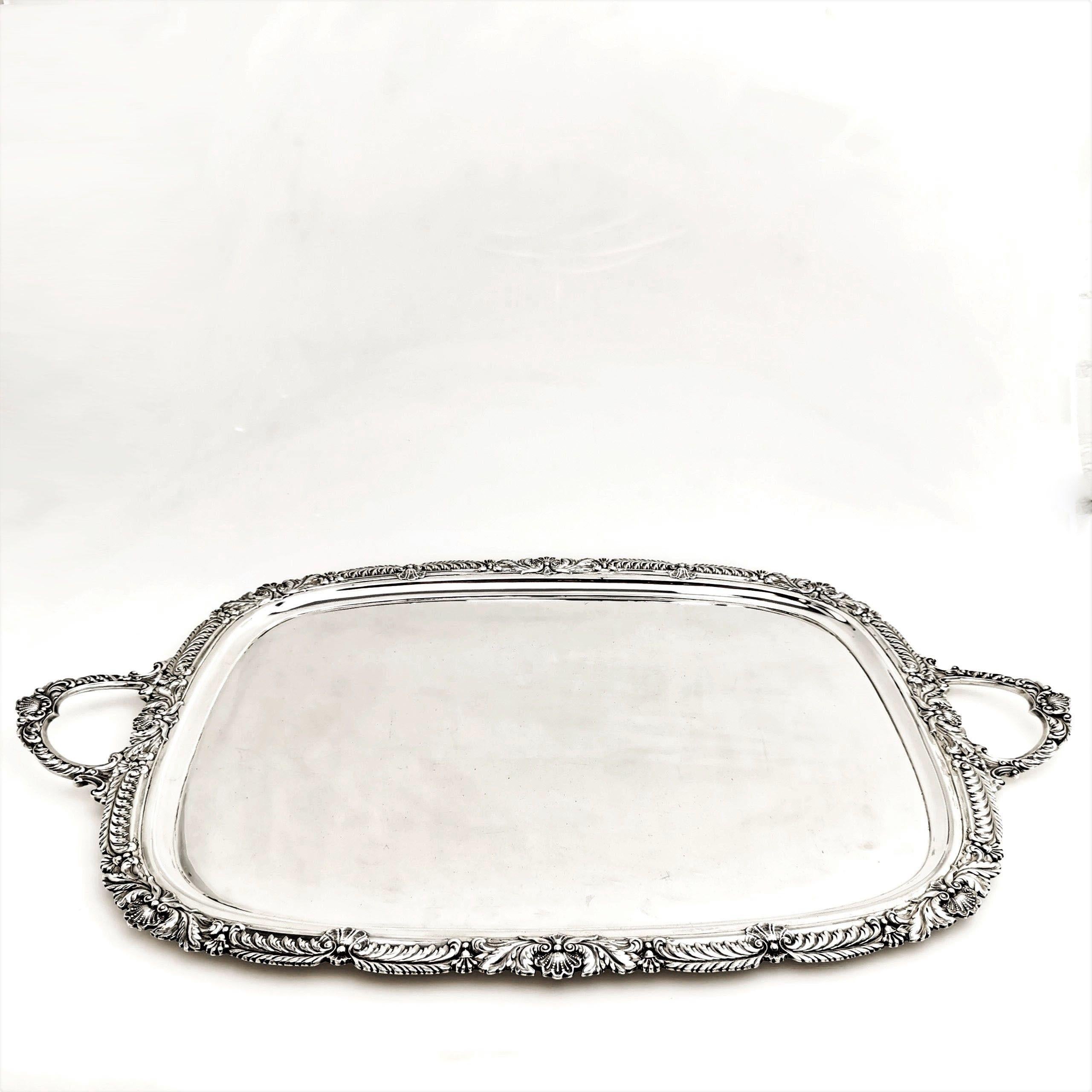 An impressive solid Silver Serving Tray with an elegant shell and gadroon border. This large silver Tray has two shell embellished handles.
 
 Made in Sheffield in 1908 by Marples & Co.
 
Approx. Weight - 4882g / 156.9oz
Approx. Length include
