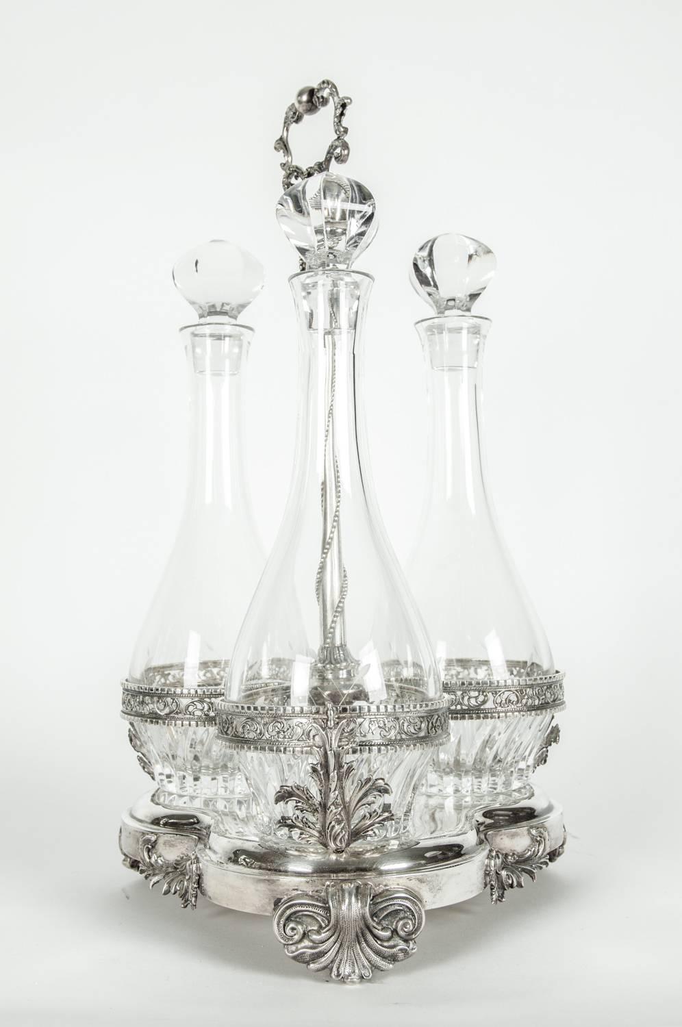 Large antique sterling silver trefoil form three cut crystal bottles decanter set in caddy. Each cut crystal decanter bottle is undersigned. The caddy is undersigned 