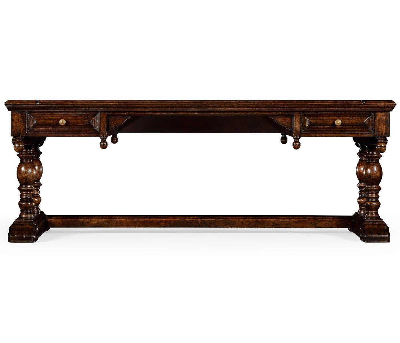 Large Elizabethan style dark oak distressed desk panelled sides and drawers, turned pendants, exposed butterfly joints to the top and an H-stretcher with carved volute feet.
Dimensions: 82