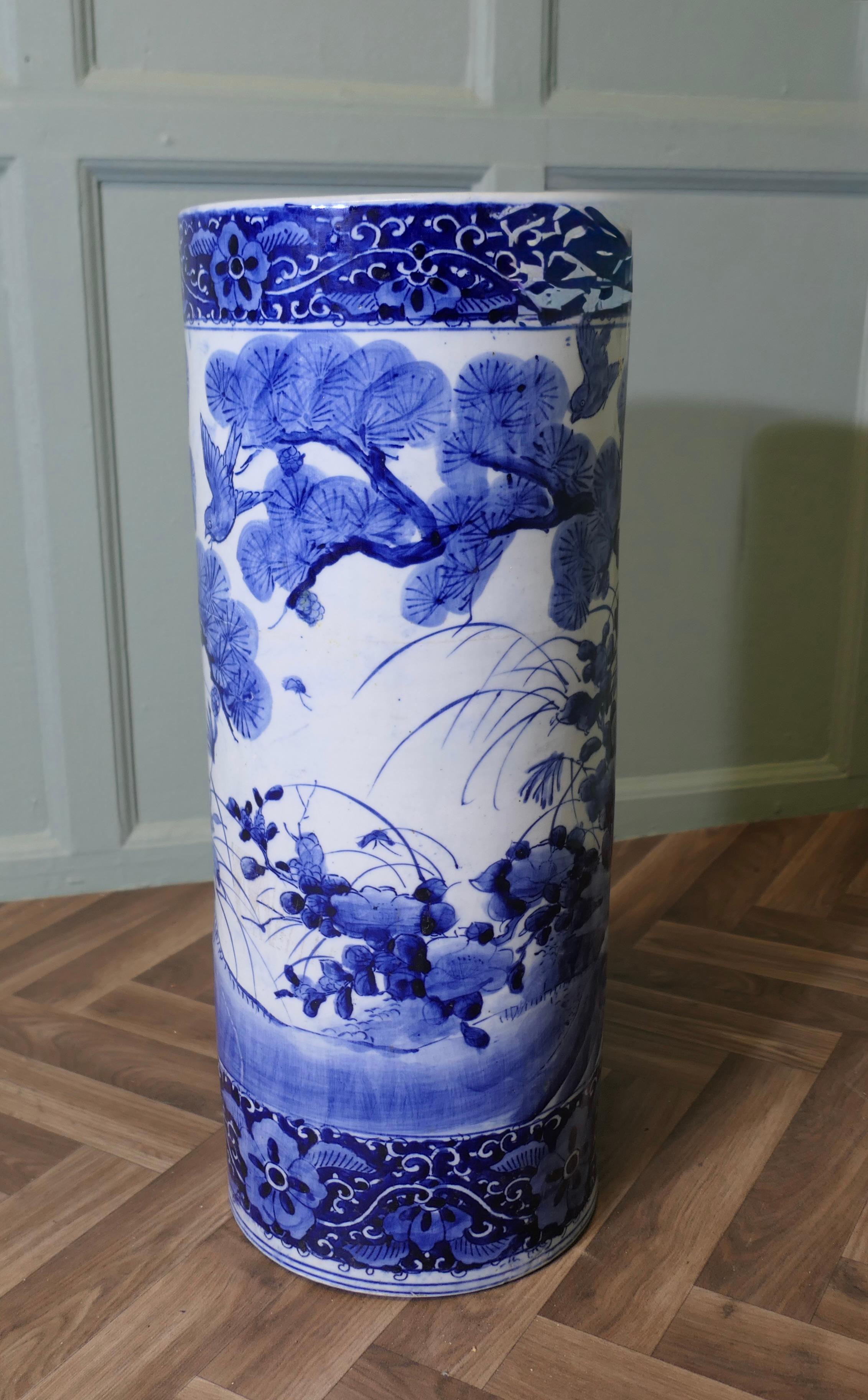 Large Antique Style Willow Pattern Design Floor Vase, Umbrella Stand

This beautiful looking large piece is round in shape, and painted in an Old Willow design this runs all the way around telling the old story with lucky birds, it is 24” tall and