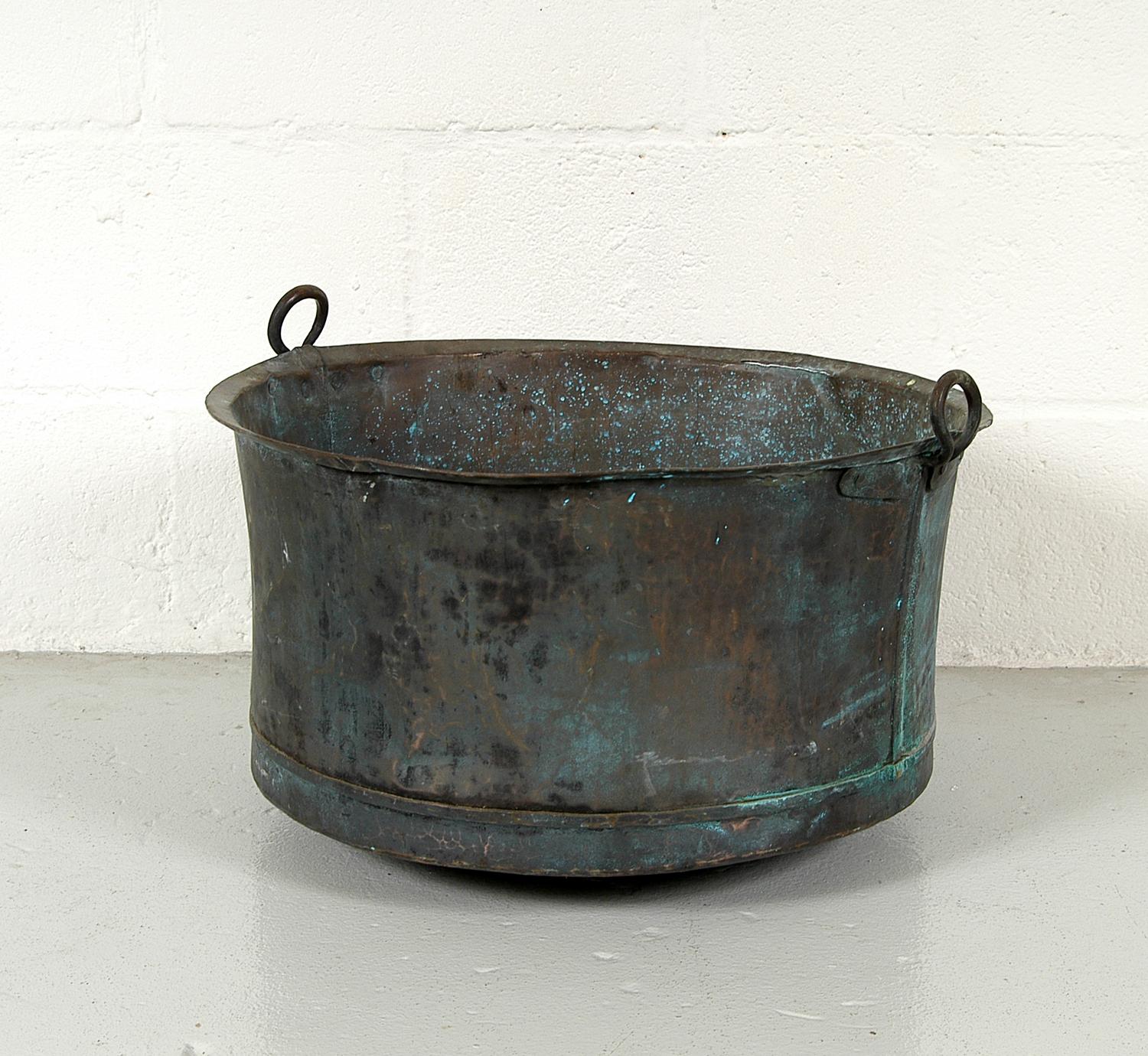 Antique Swedish laundry tub made from hand beaten copper with twin circular wrought copper handles, with the most amazing verdigris patina. This would have originally sat on a steel tripod base, but is now a versatile and useful garden planter.