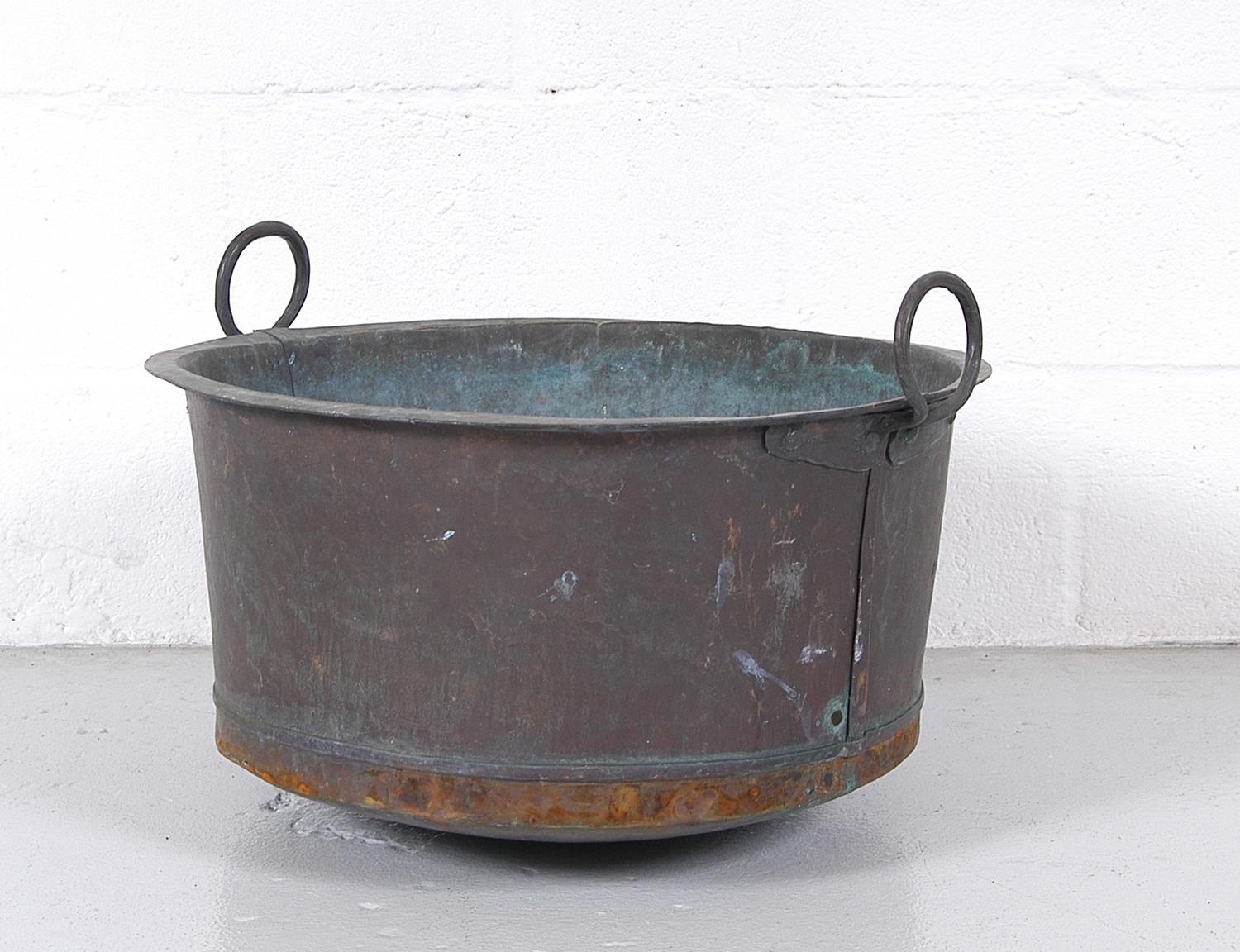 Antique Swedish laundry tub made from hand beaten copper with twin circular wrought copper handles, with great verdigris patina. This would have originally sat on a steel tripod base, but is now a versatile and useful garden planter. Alternatively