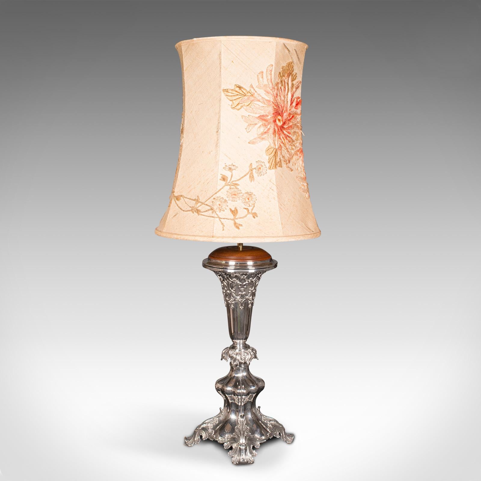 This is an antique decorative table lamp. An English, silver plate and walnut side light, dating to the late Victorian period, circa 1900.

Impressive statement lamp standing at over 3' tall with shade
Displays a desirable aged patina and in good