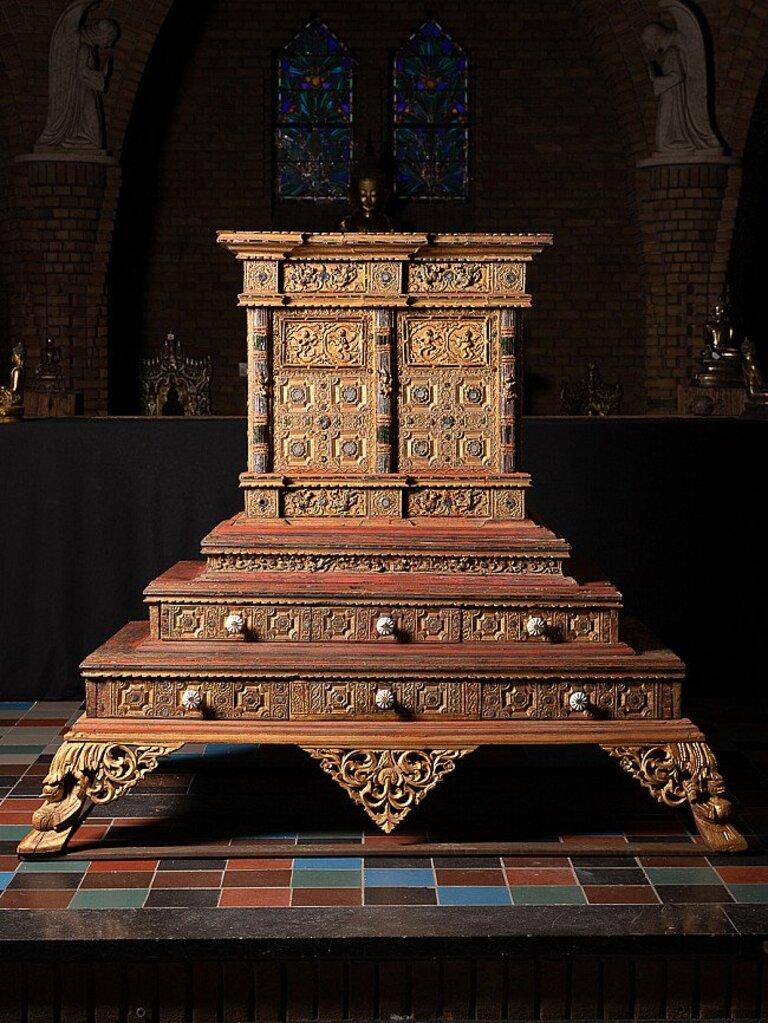 Material: wood
144 cm high 
162 cm wide and 109 cm deep
Fully gilded with 24 krt. gold
Mandalay style
Originating from Burma
19th century
With 'hidden' doors on the backside
It must have been an important piece at a monastery or temple !
 