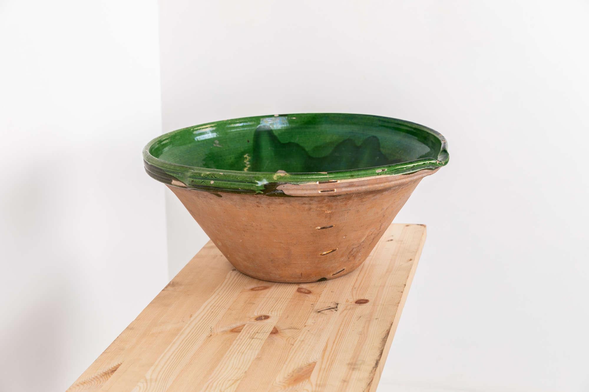

A very large 19th century dairy bowl. c.1880

Terracotta with beautiful green glazed bowl with wonderful ancient stapled repair. Some minor chipping here and there, but a great decorative item.
