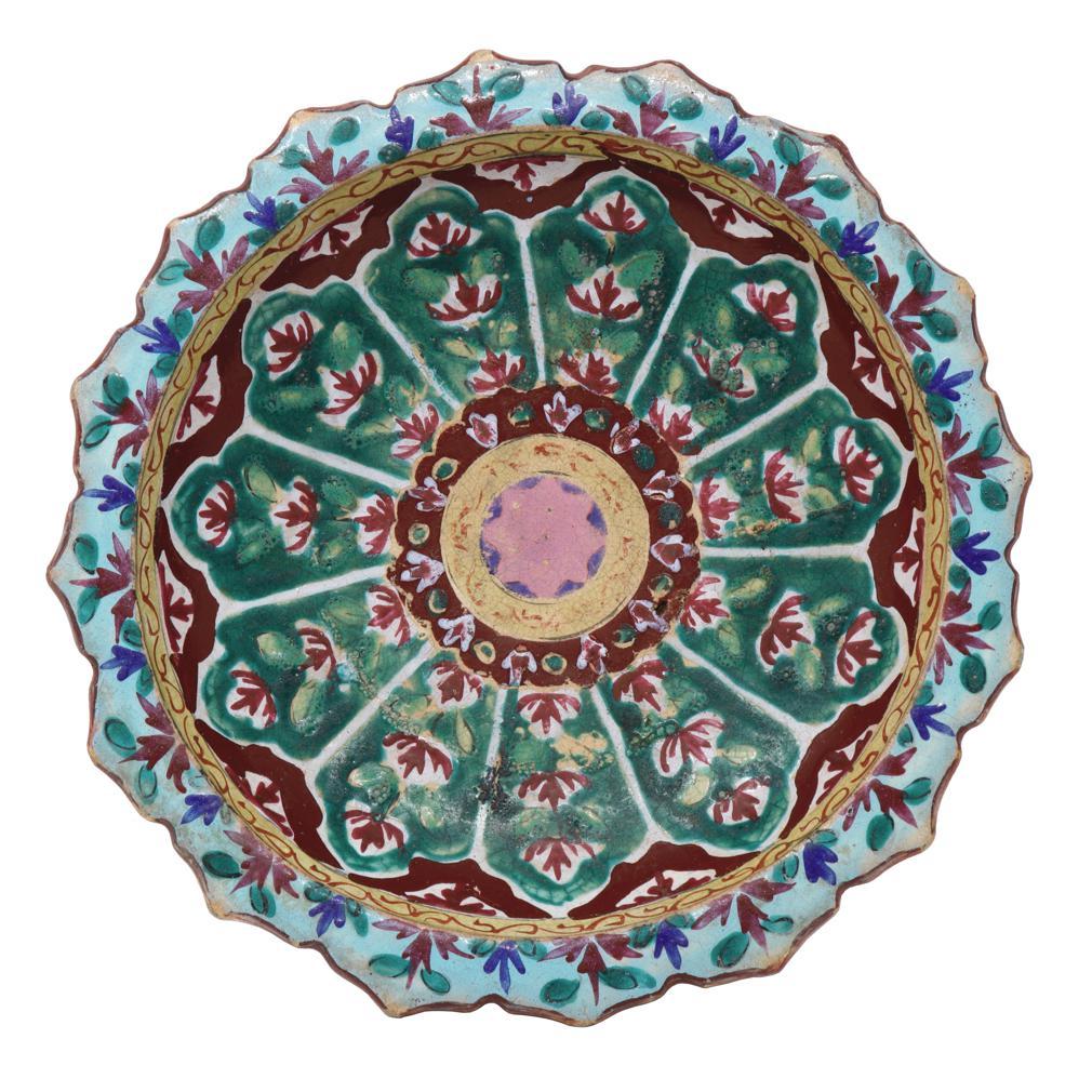 Large Antique Thai Bencharong Stem Plate. A stoneware tazza having a domed pedestal base under a foliate rim dish. Traditionally enameled in a green and red palette with accent colors of turquoise, yellow, white, blue and pink in a circular
