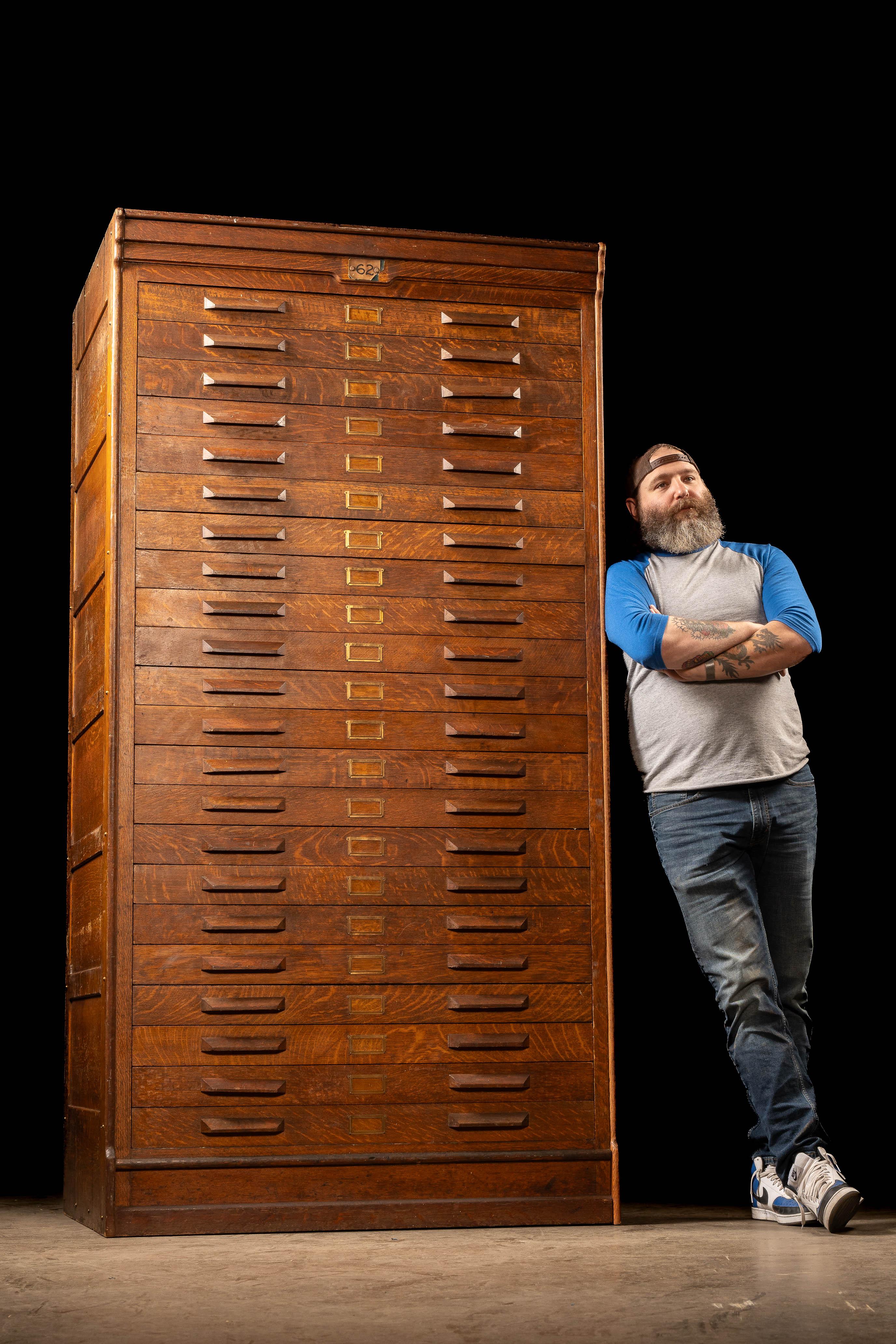 This towering and visually arresting antique wooden flat file cabinet was likely used in a drafting office, print shop, or architectural firm. With its 22 large flat drawers, this piece would have originally stored blueprints, maps, lithographs, or