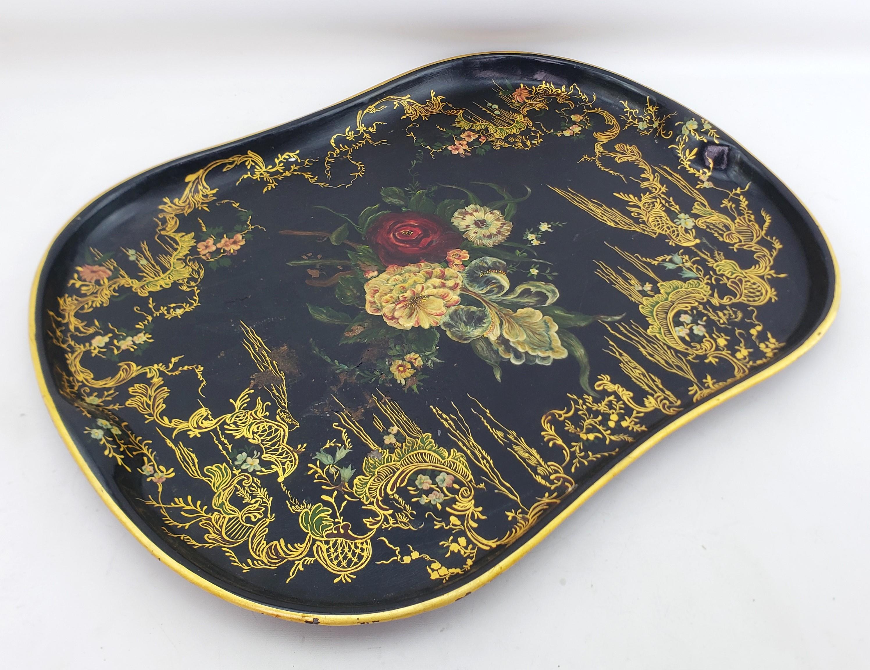 This huge antique serving tray is unsigned, but presumed to have originated from England and date to approximately 1880 and done in the period Victorian style. The tray is composed of pressed steel with and black background with an elaborate