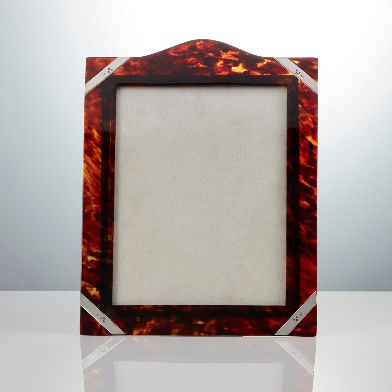 A Large Antique Tortoiseshell Photo Frame with Silver Overlay Corners dated London 1897.

This mid 19th century frame is a great size with unusual silver overlay decoration to each corner. The shell retains it’s translucent quality. This piece is