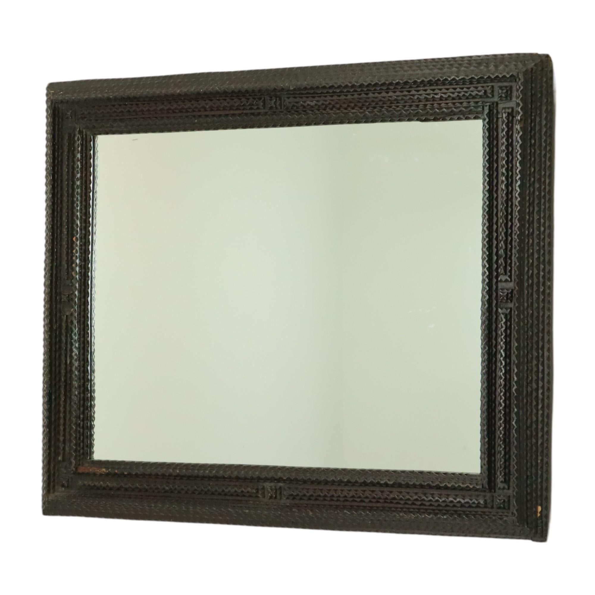 Exceptional and very rare rustic tramp art wall mirror from the late 19th century, originating from Austria, circa 1870.

This unique mirror impresses with its exceptionally designed frame, decorated with carefully crafted, carved recesses and is