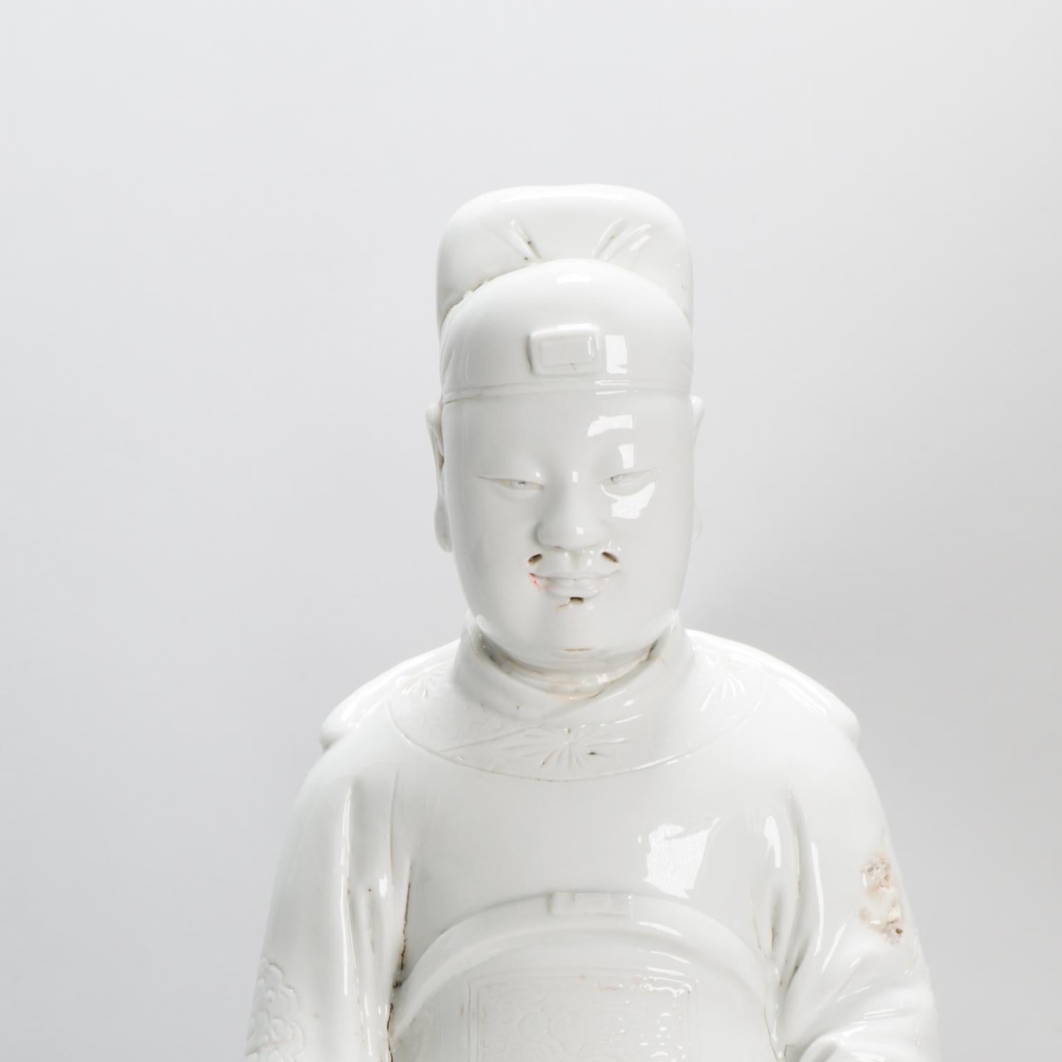 A Transitional or Kangxi Blanc de Chine Porcelain Guandi, from Dehua Kilns, 17th century.

Blanc de Chine Porcelain :
The porcelain known in the West as Blanc de Chine was produced 300 miles south of the main Chinese kiln complex of Jingdezhen. The
