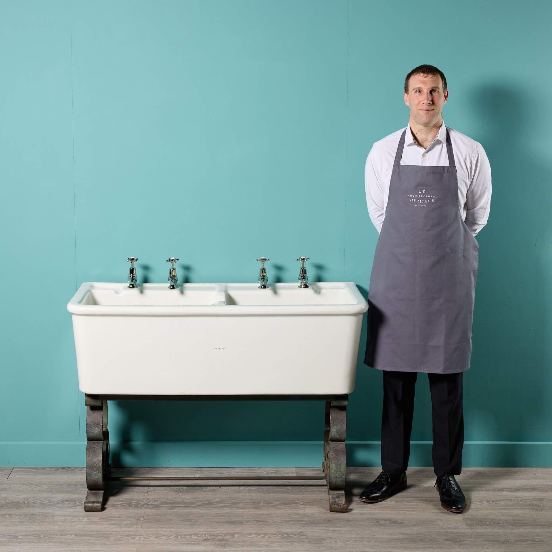 A large antique Twyfords twin Belfast sink.

It displays two large deep stoneware Belfast style sinks differing in depth, sat on a wrought iron stand showcasing large eye-catching scrolls.

Dating to circa 1900, this twin sink was likely once used