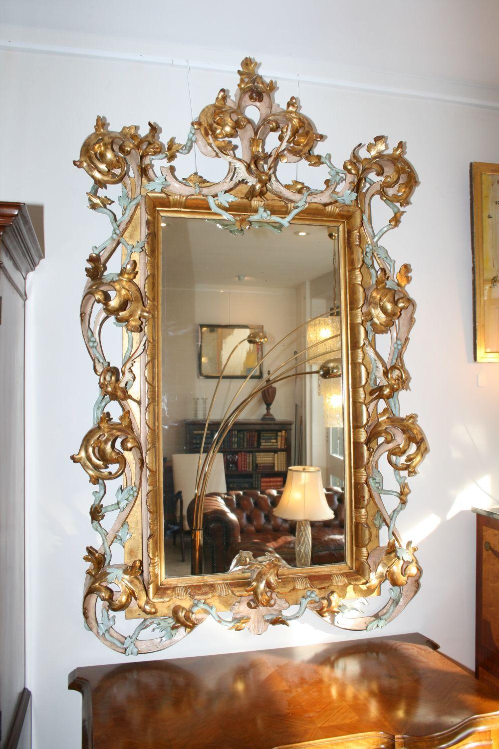 Very large and decorative antique giltwood mirror dating from the early 19th century and possibly older. We believe it’s Italian and very unusual in the way it’s not only gilt, but has light blue and cream finishes too. The frame is beautiful and