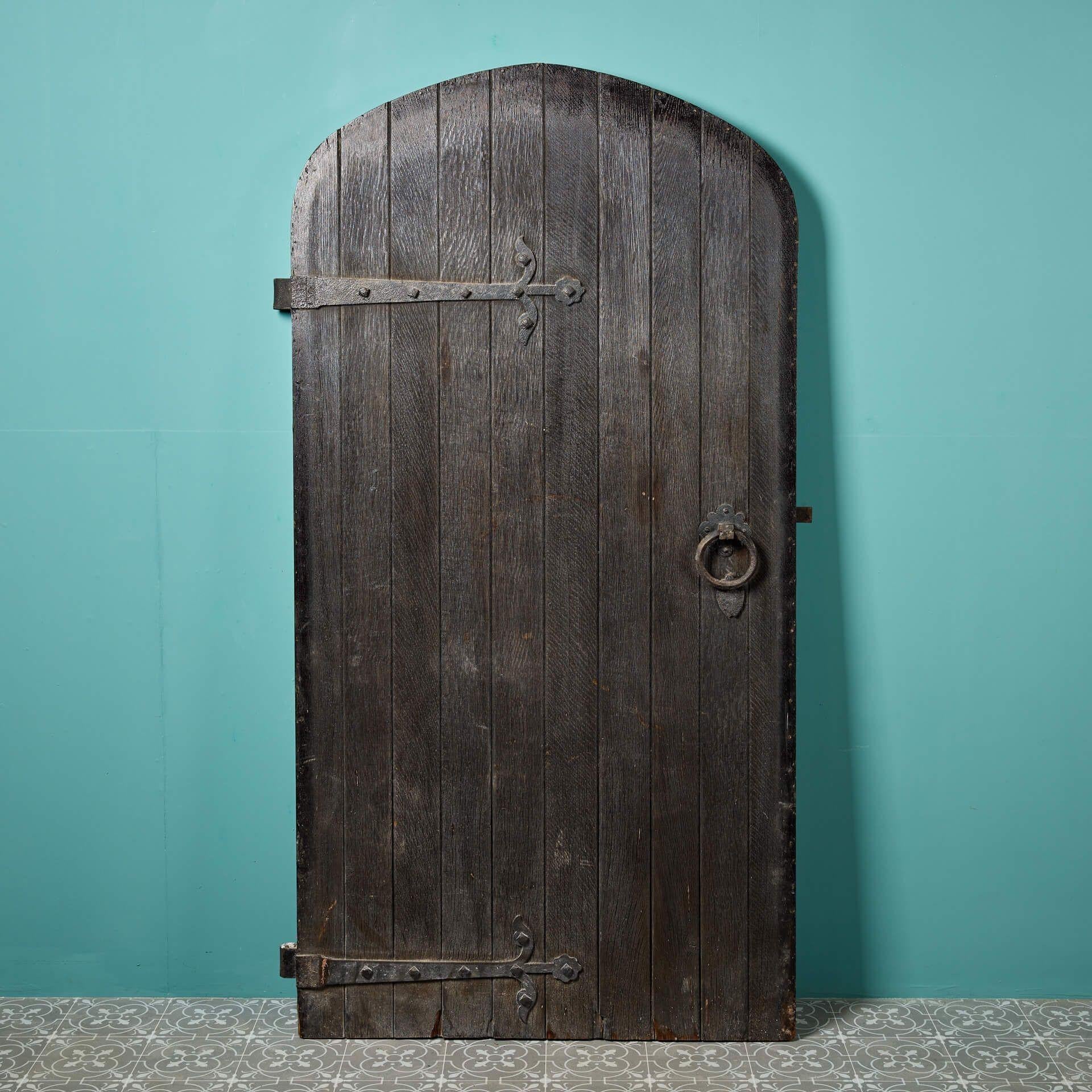 A large antique Victorian arched oak exterior door, reclaimed from St Mary’s church, Ely.

Dating to circa 1880, this exceptional door has kept its good quality still displaying its original wrought iron hardware and impressive oak faced lock and