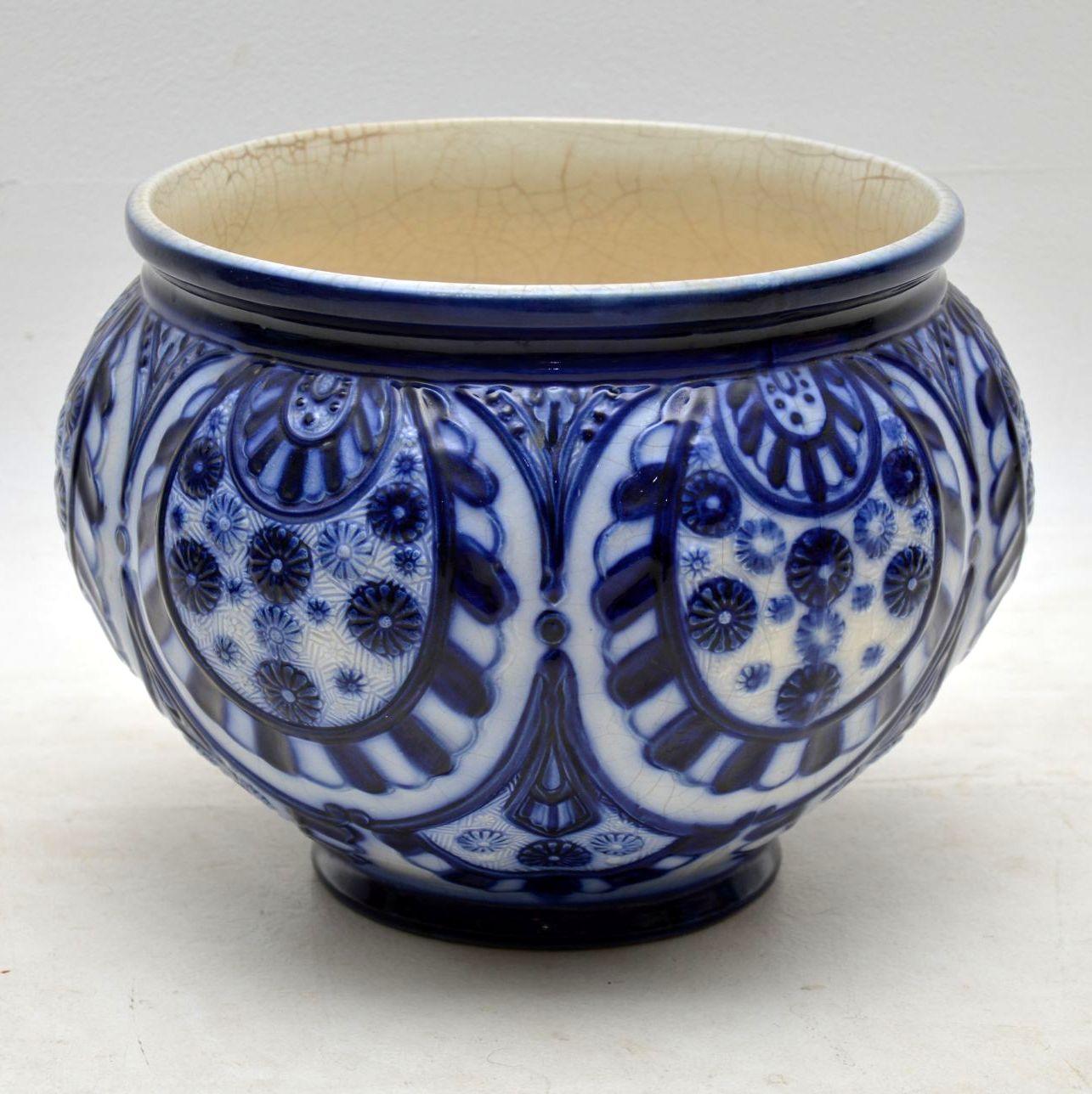 Large antique Victorian ceramic flower bowl in excellent condition. There is natural crazing inside, but no damage. This bowl has deep blue and white patterns all over with lots of embossings. I believe it dates to around the 1880-1890s