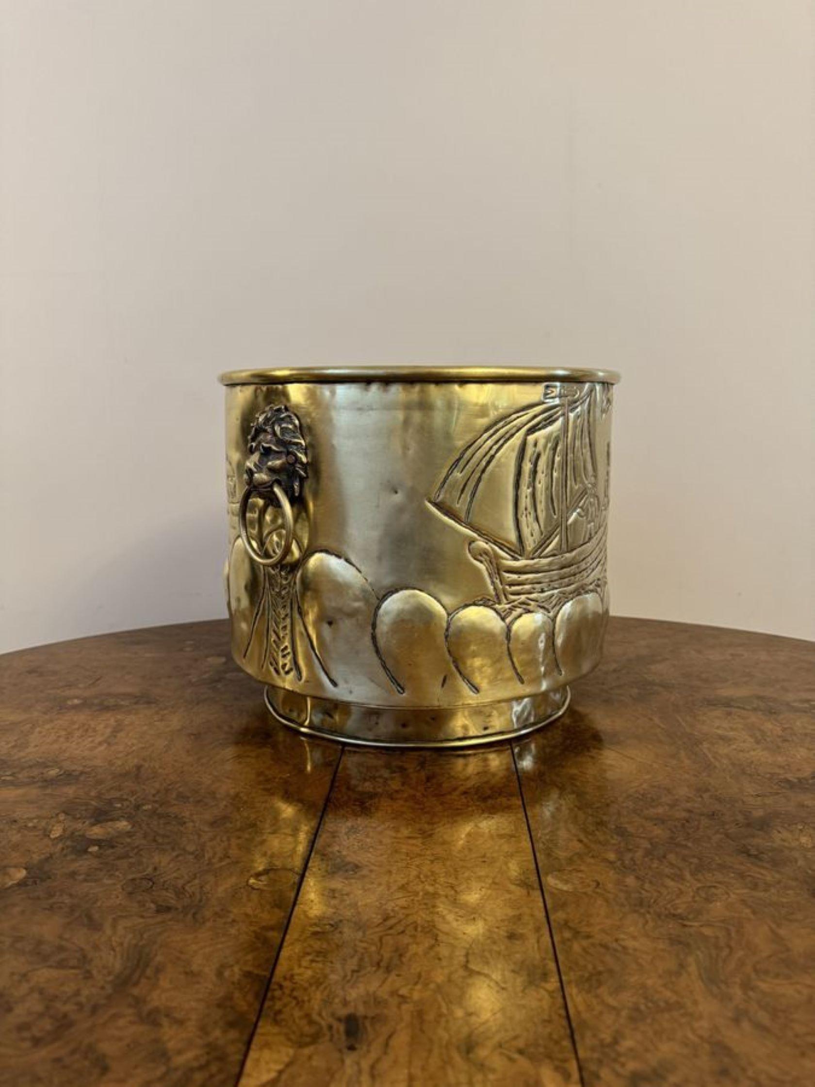 Large Antique Victorian Dutch Brass Jardiniere having a quality antique Victorian Dutch brass jardiniere, Having lions heads ring handles to the sides, decorated with traditional scenes with figures, boats, windmills and birds having a circular