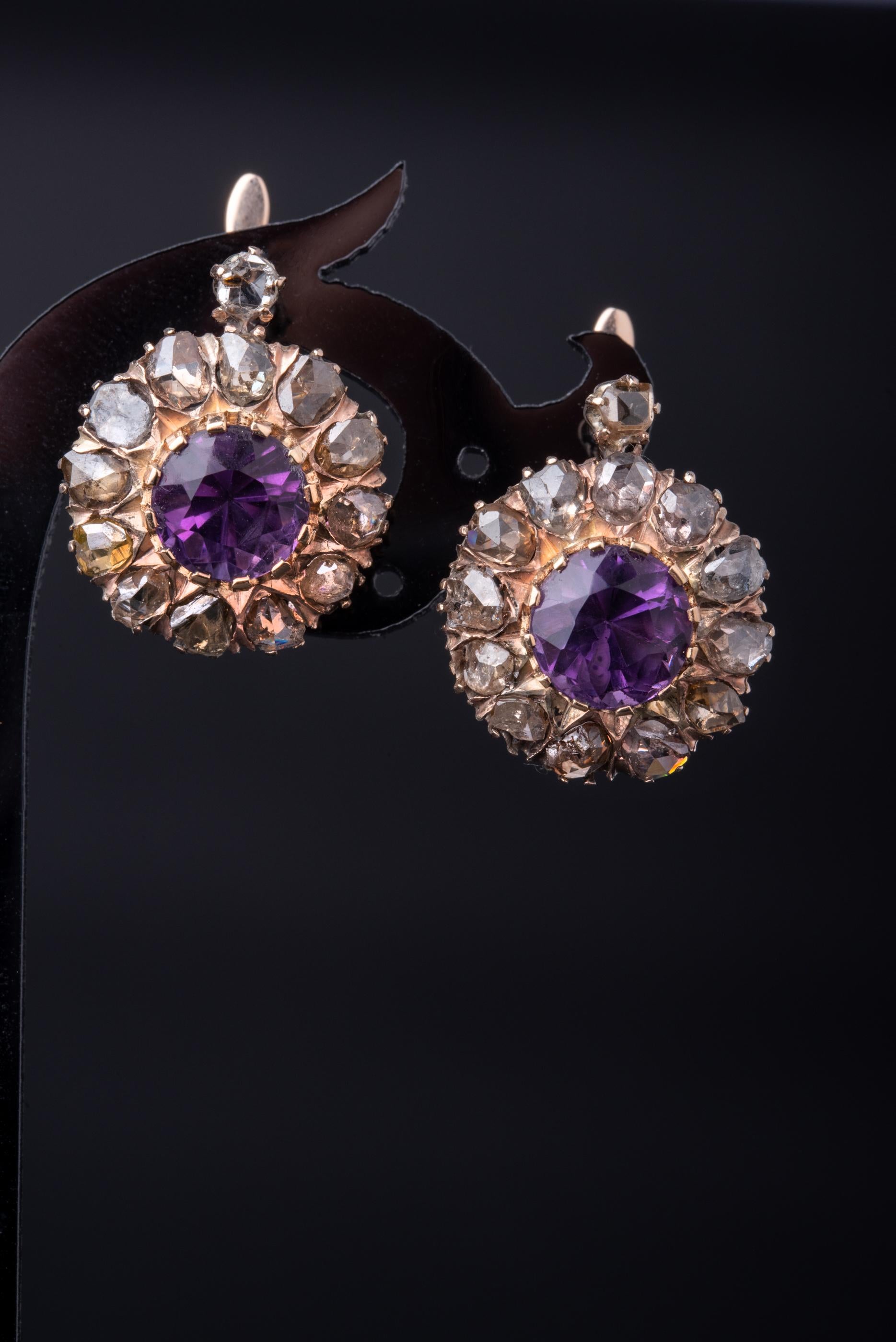 A stunning pair of antique diamond earrings made of solid 12 ct gold. 

The earrings have a classic floral design and are set with 26 rose cut diamonds (13 diamonds each). The stones are preserved in a very good condition with a minor surface wear