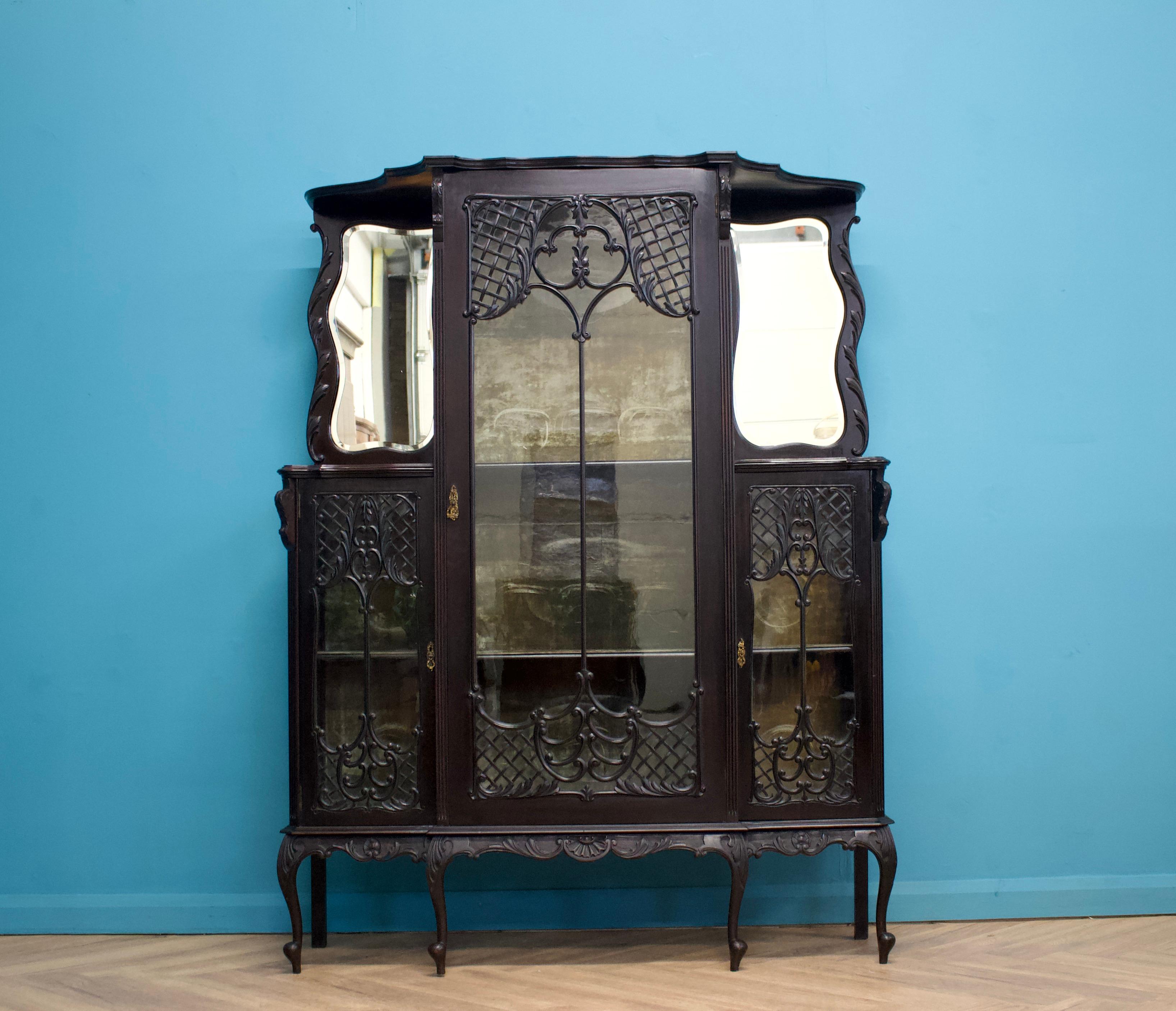 A beautifully ornate Victorian mirror back ebonised display cabinet, in the gothic revival style

Internally there are removable shelves inlaid with a velvet fabric.  

This could be used as a drinks cabinet