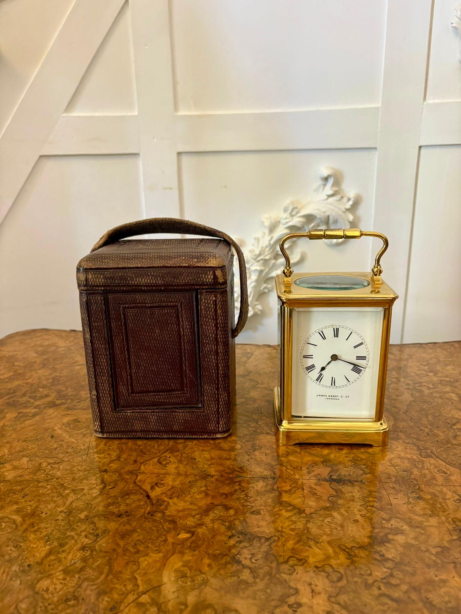 Large antique Victorian quality brass carriage clock having a quality brass case with bevelled edge glass, swing carrying handle to the top, porcelain dial with Roman numerals, original hands, 8 day French striking movement. Original leather