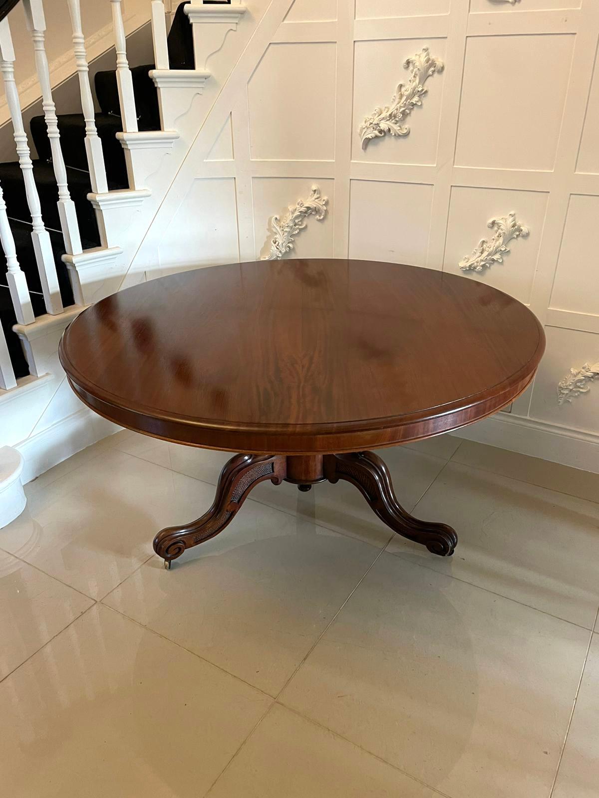 Large Antique Victorian quality figured mahogany circular centre table having a large quality figured mahogany circular shaped tilting top with a moulded edge supported by a shaped turned mahogany column pedestal standing on shaped carved cabriole