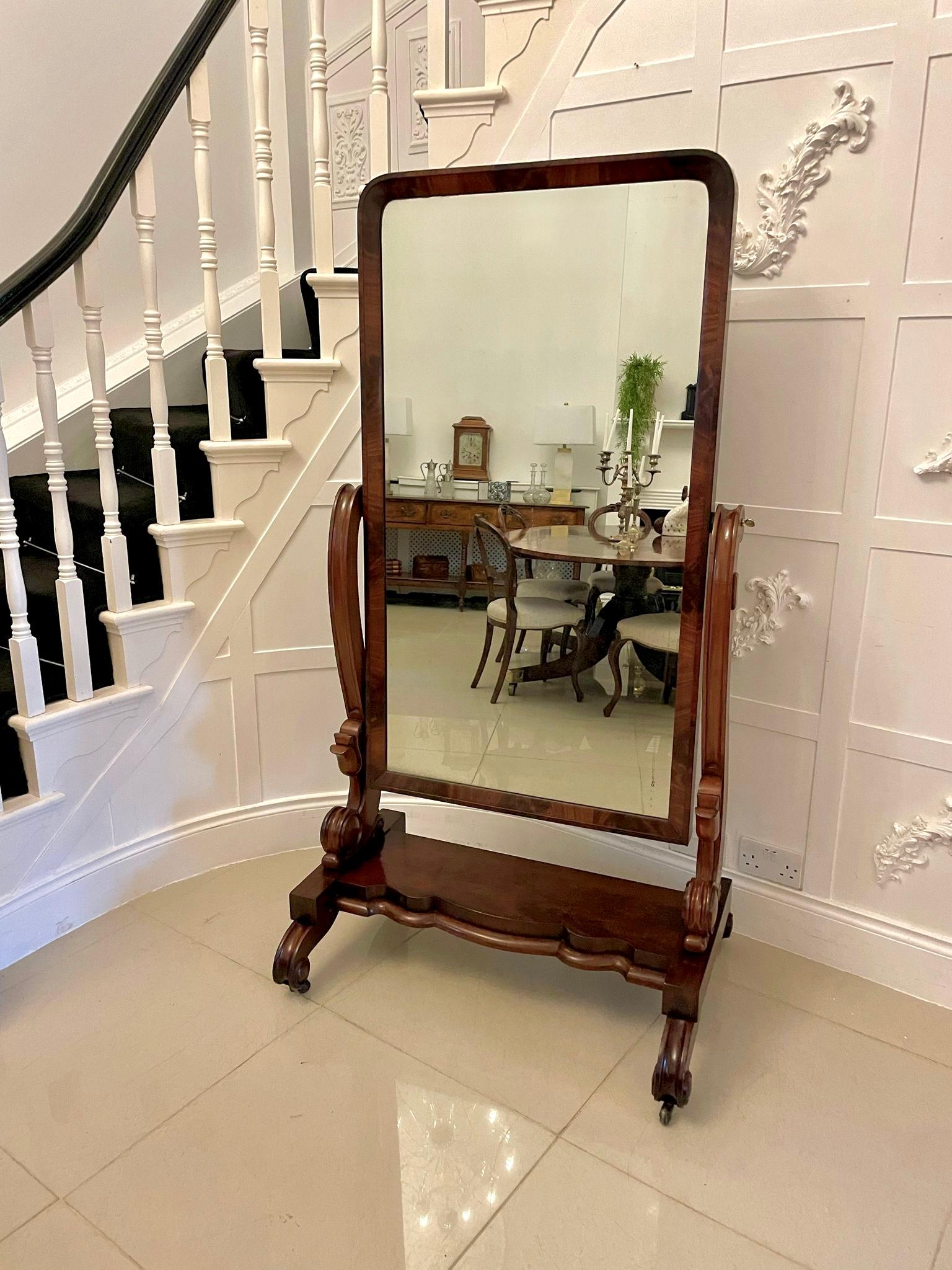 Large antique Victorian quality mahogany cheval mirror having the original adjustable mirror in a quality figured mahogany frame supported by large scroll shaped supports with elegant carved tulips standing on scroll shaped feet with original