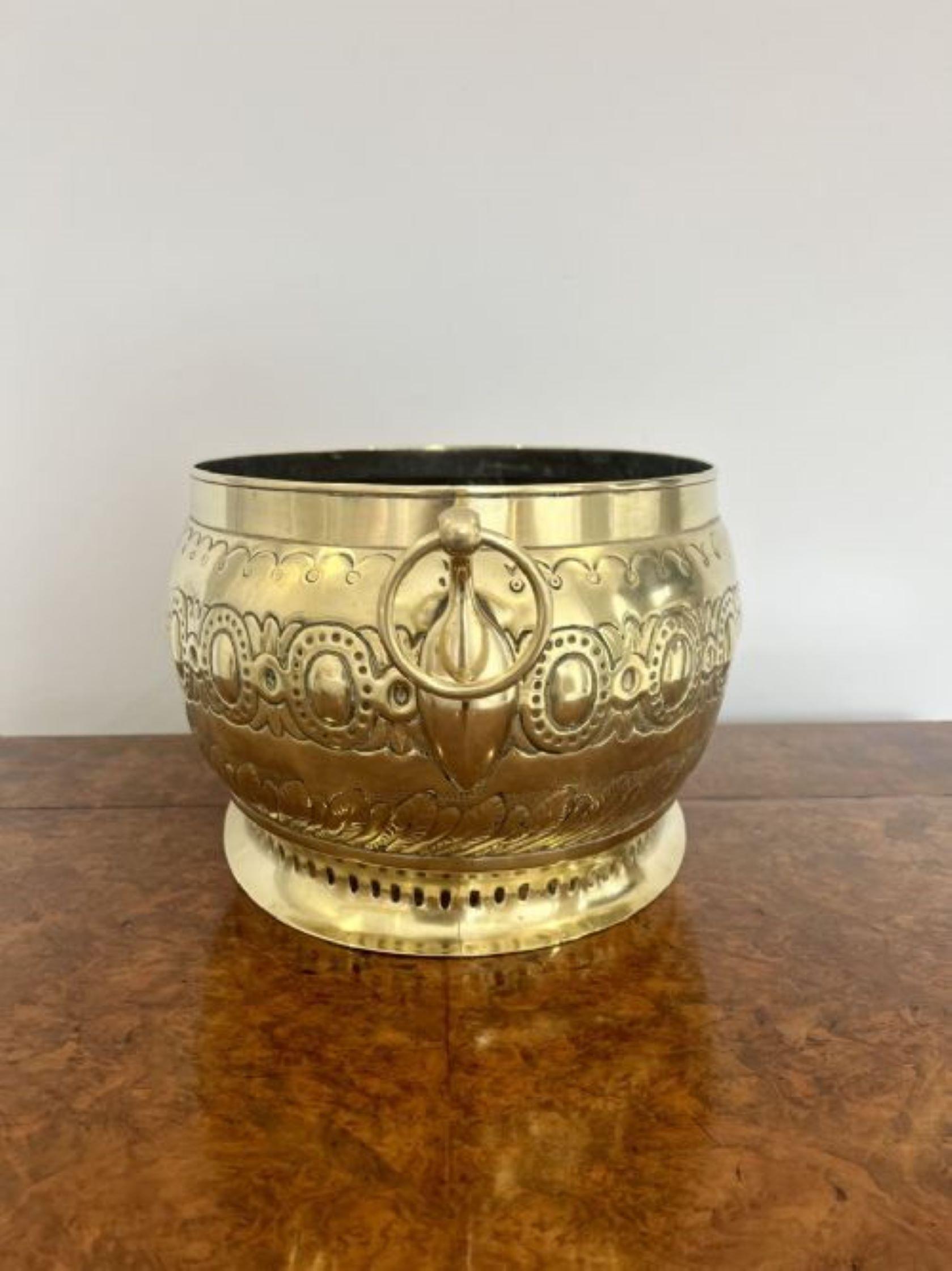 Large antique Victorian quality ornate brass wine cooler having a large oval antique Victorian quality brass wine cooler with ornate engraved decoration with carrying handles to both sides standing on a oval base.