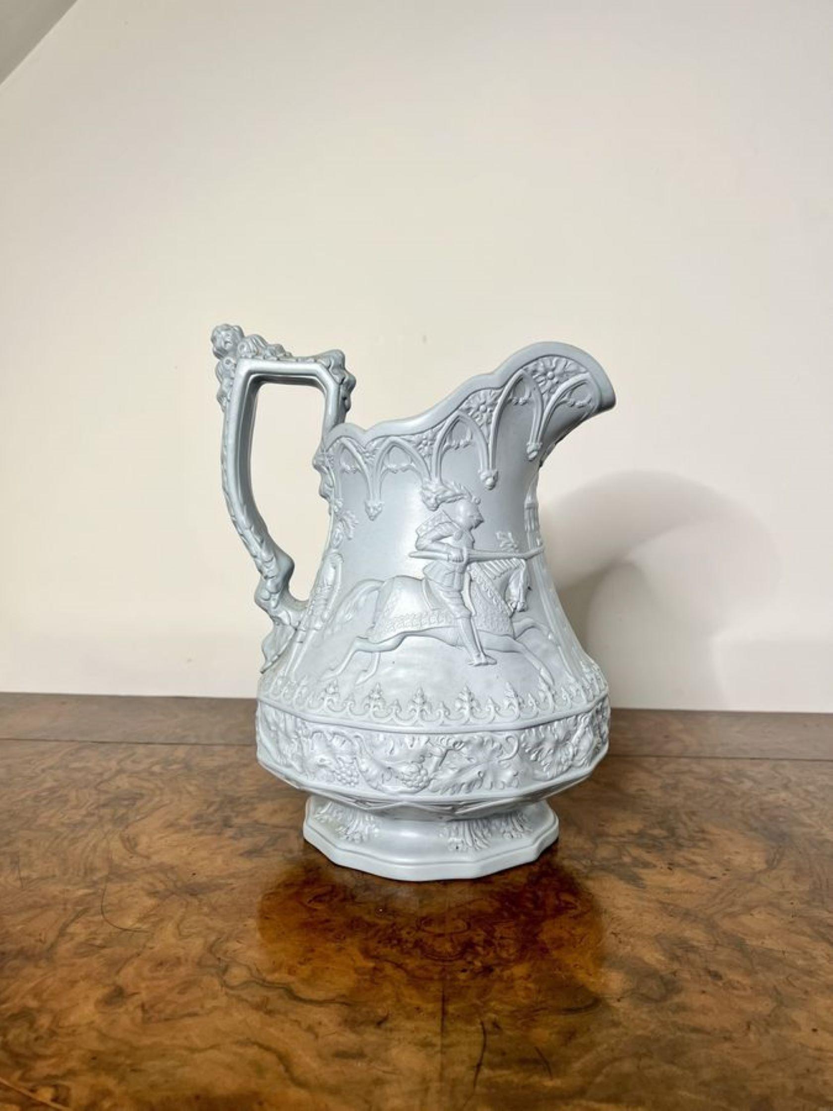 Large antique Victorian Ridgway & Sons quality jug with a shaped handle to the back,  decorated throughout with a medieval design of knights jousting standing on a circular base. 

D. 1880