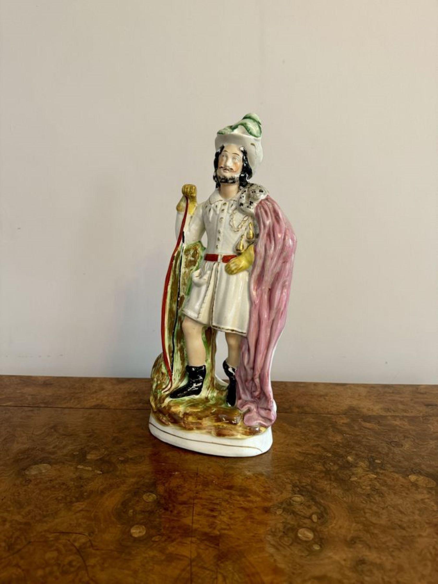 Large antique Victorian Robin Hood Staffordshire figure, having a quality large antique Staffordshire figure of Robin Hood standing with a bow to his side, hand painted in wonderful pink, green, clack, brown and gold colours raised on an oval gilded
