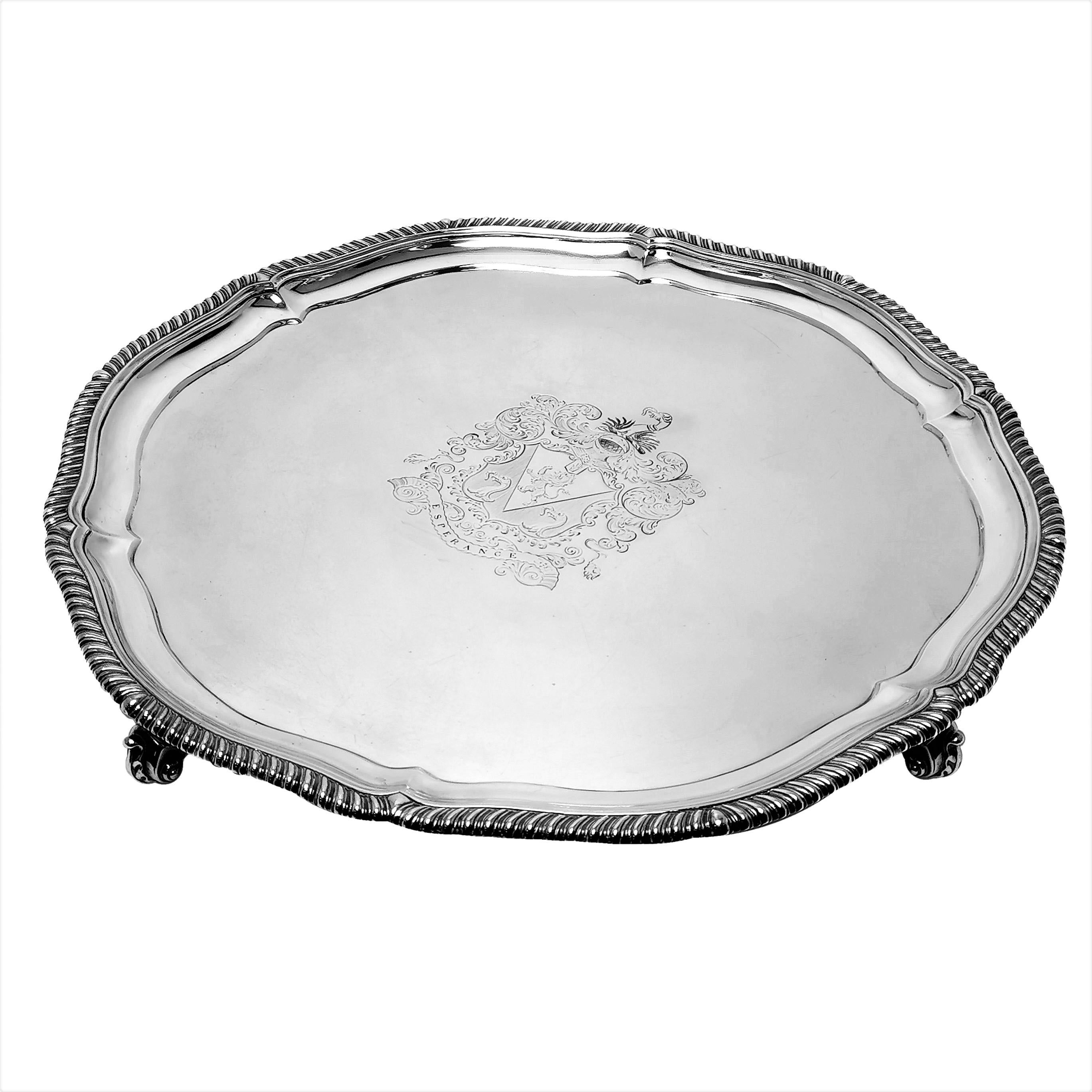 An impressive Antique Victorian Silver Salver with a classic gadroon pattern border. This oversized Salver has a large engraved crest in the centre. This salver is of notably large size and good weight.

Made in London, England in 1874 by