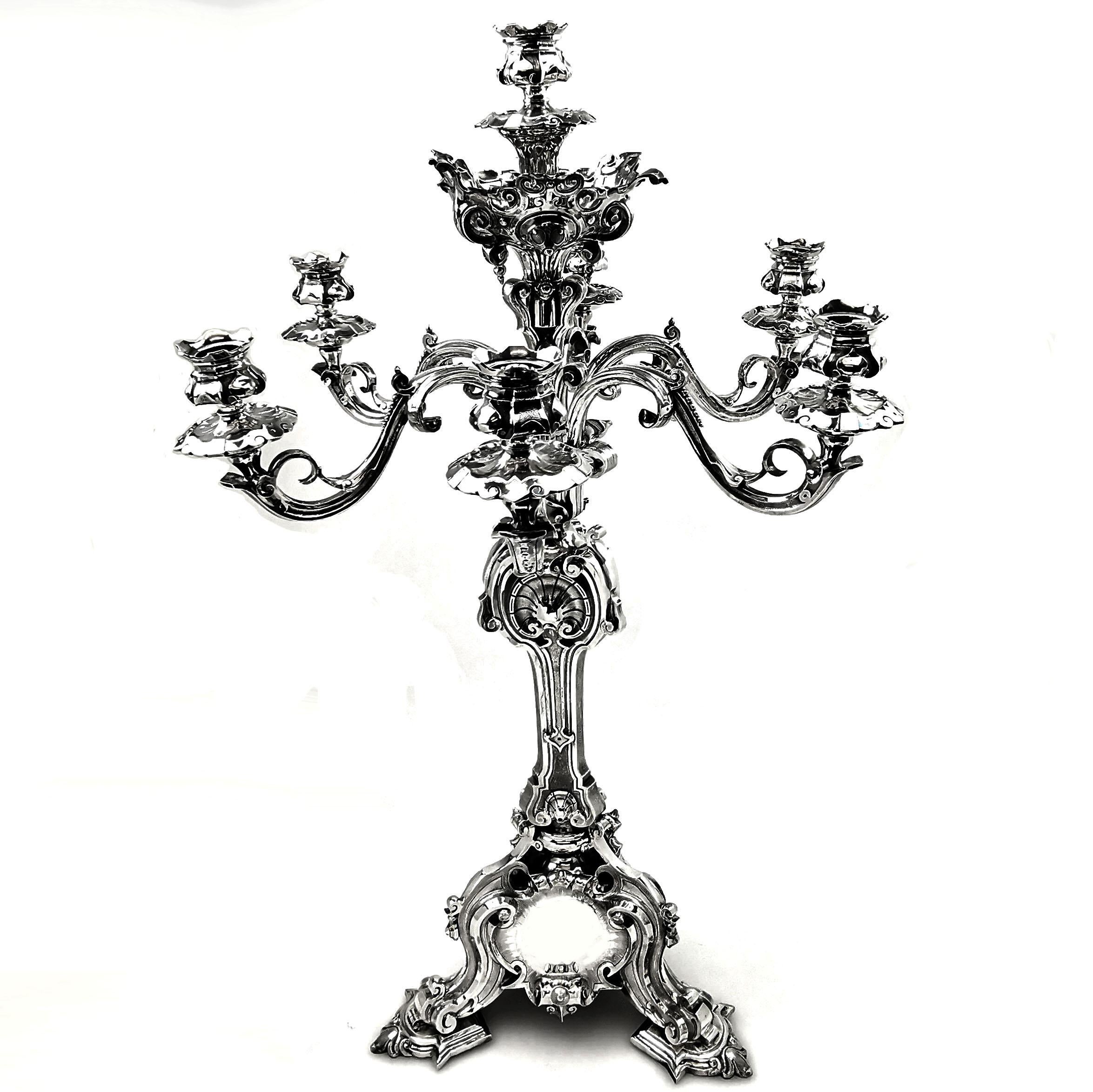 A magnificent antique Victorian sterling Silver Candelabrum. This Victorian Candelabrum stands on an impressive three footed base, with three circular cartouches. The branches of the Candelabrum are ornate scroll and leaf designs, and the column of