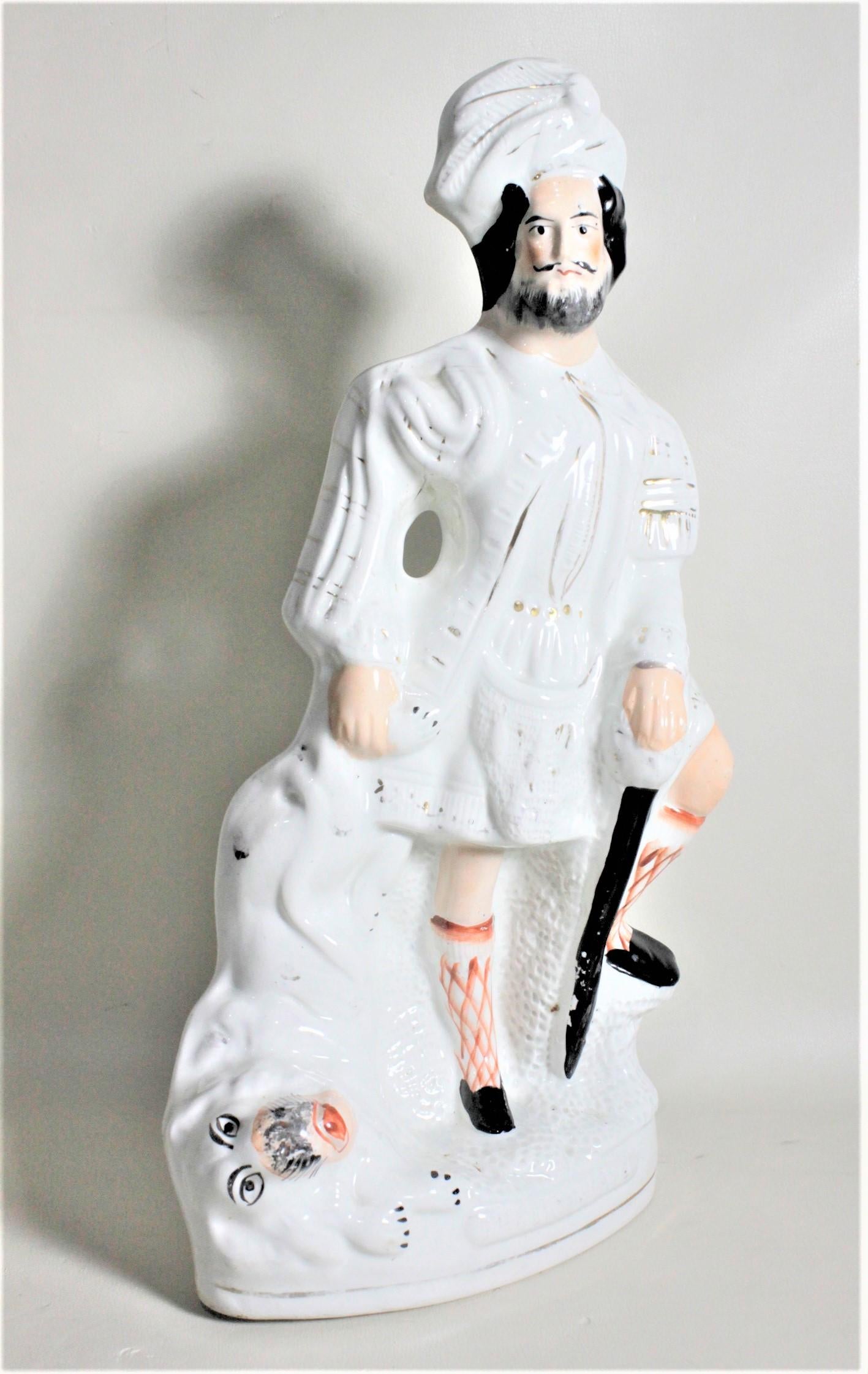 This large antique ceramic figurine was made by Staffordshire of England in circa 1890 in the period Victorian style. The figure is done in the typical cream glaze Staffordshire is known for and has hand painted accents. The figure depicts a