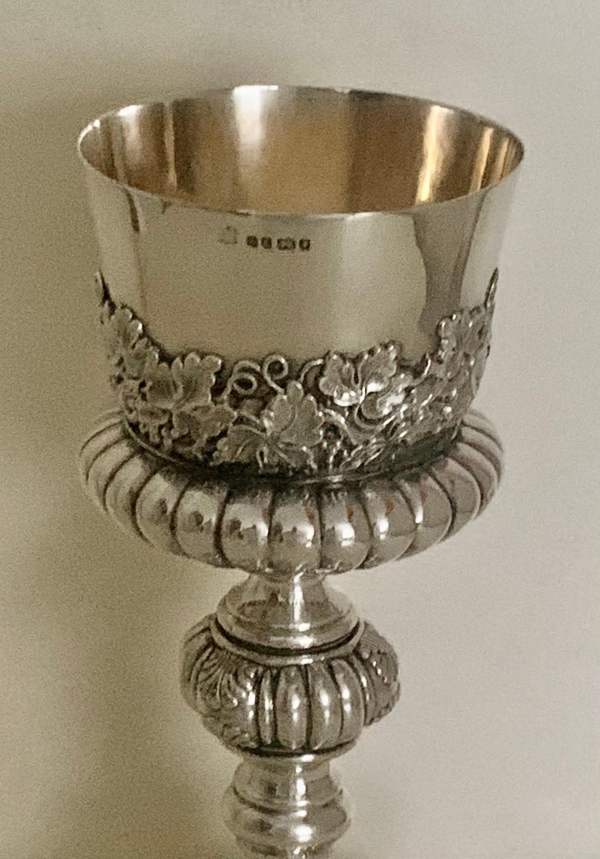 This is a stunning large antique Victorian sterling silver chalice. Hallmarked in Sheffield in 1872 and was Manufactured by CB. AOG this attractive,
silver chalice cup is heavily embossed with a Grape vine design and fluting and is approximately