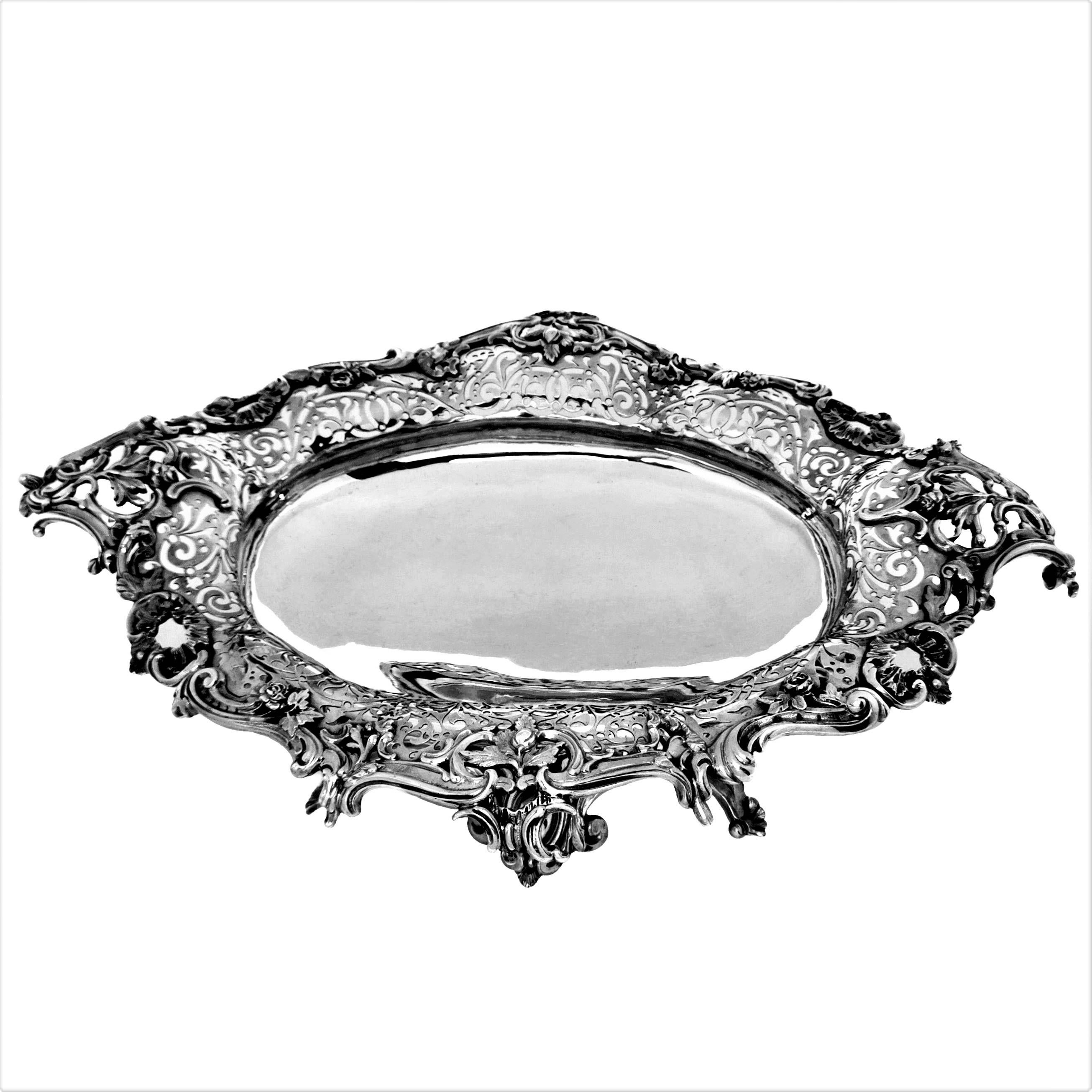 A magnificent Antique Silver Dish / Bowl with a beautiful pierced design on the rim and an applied chased border. This Dish is of substantial size and is raised on eight feet to create an impressive statement piece large enough to be used as a